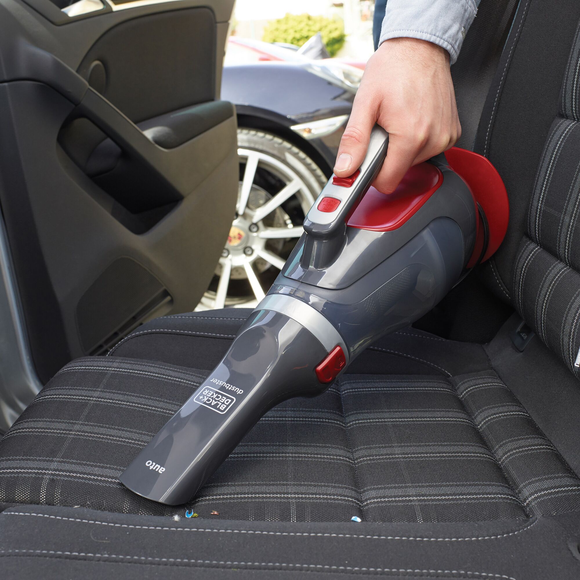 BLACKDECKER ADV1200 handheld vacuum cleaning car seat, photography showing device in use.