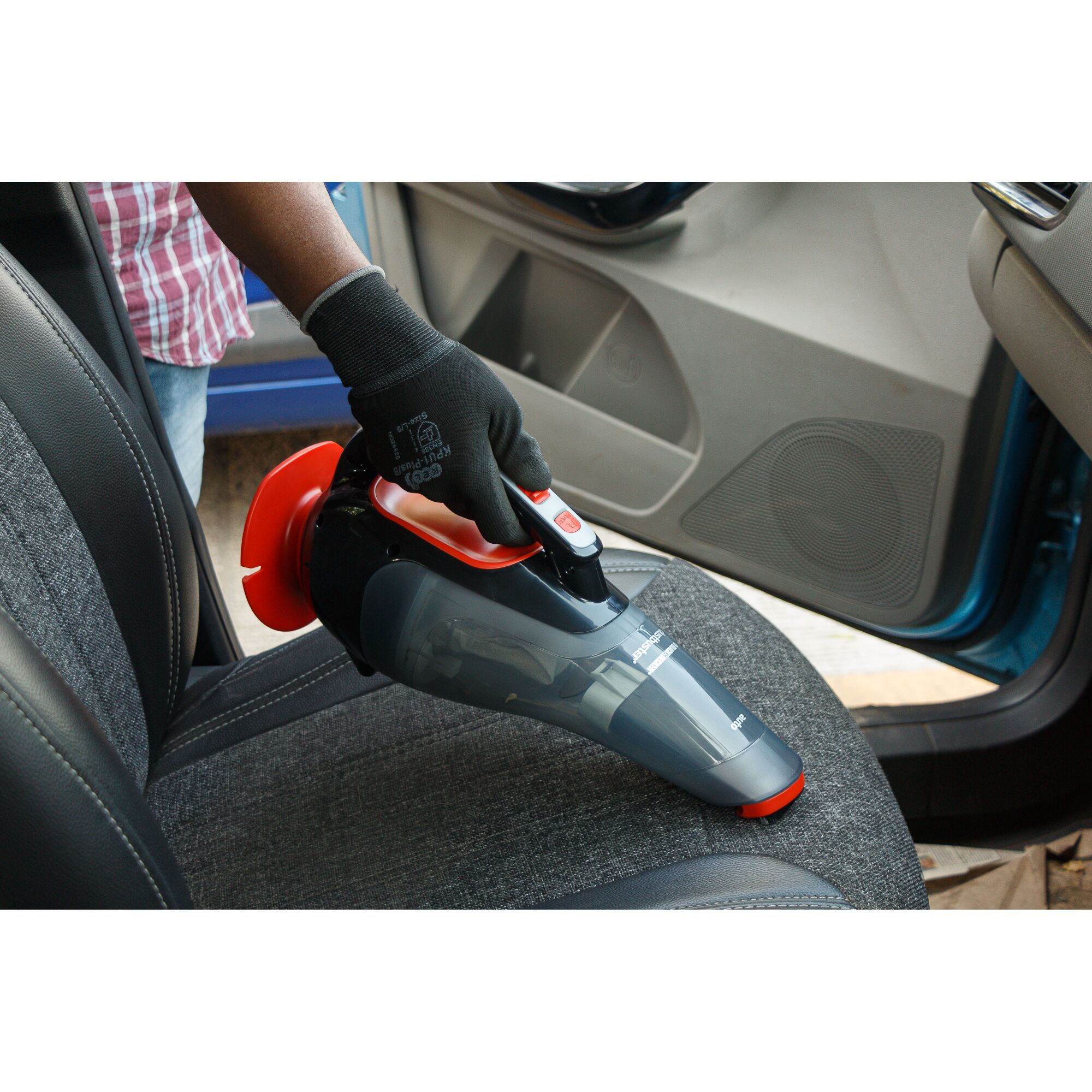 BLACKDECKER ADV1210 handheld vacuum cleaning car seat, photography showing usage.
