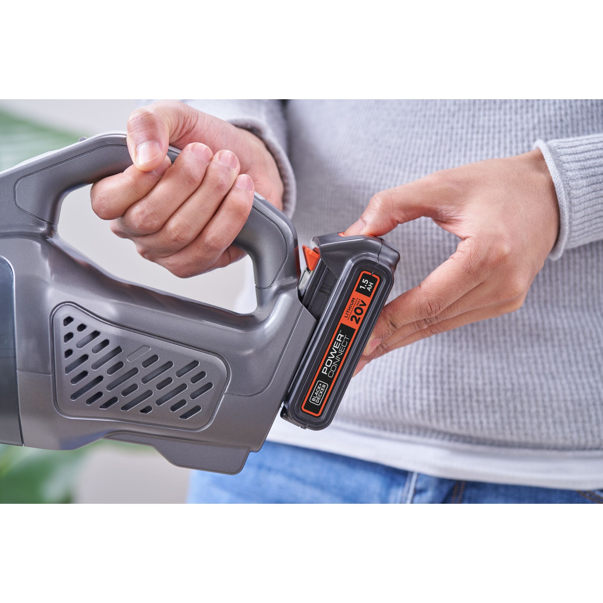 BLACKDECKER BCHV001D1E handheld vacuum with 20V battery being inserted, close-up view.