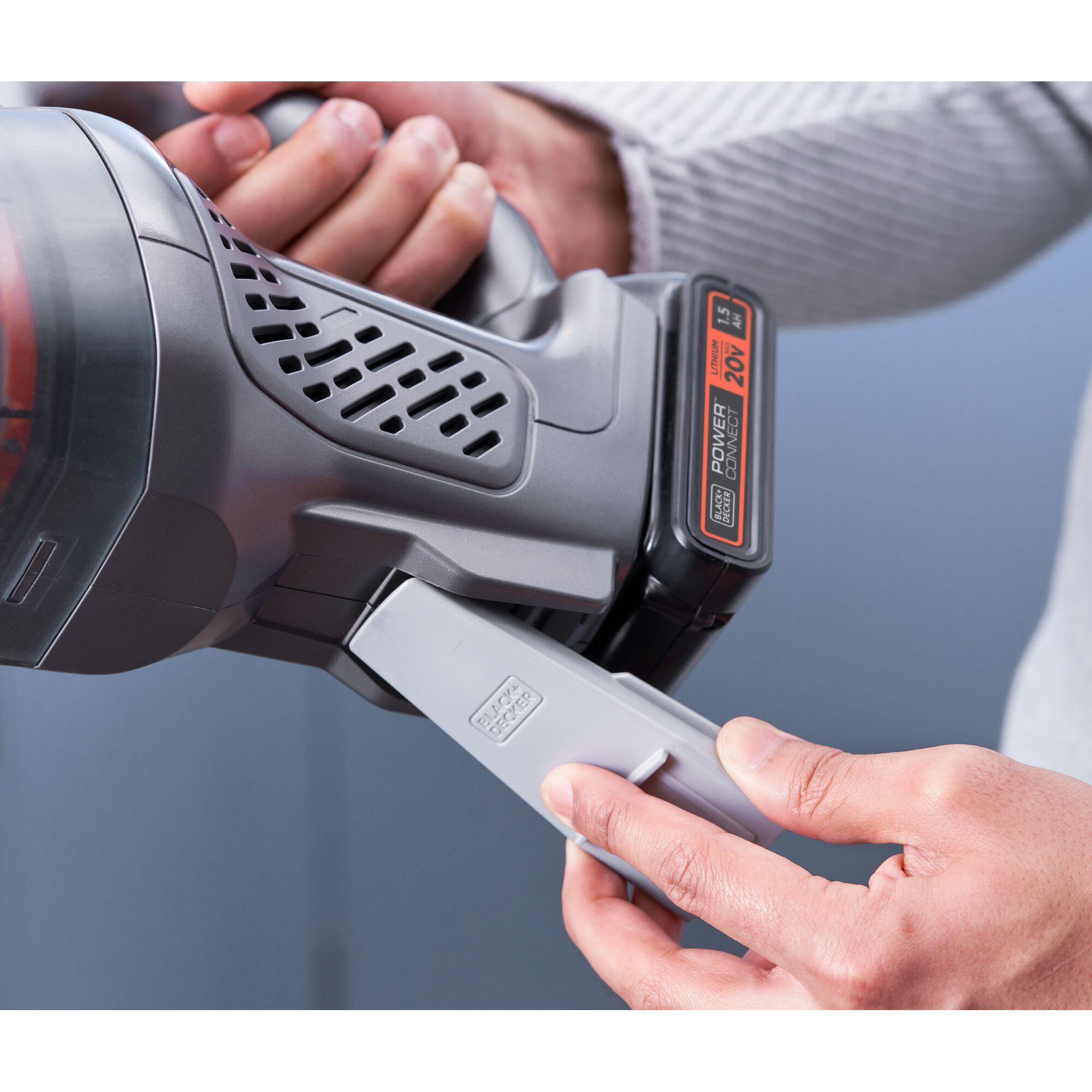 Photo of BLACKDECKER handheld vacuum BCHV001D1E with 20V battery, close-up detail of handle and attachment in use.