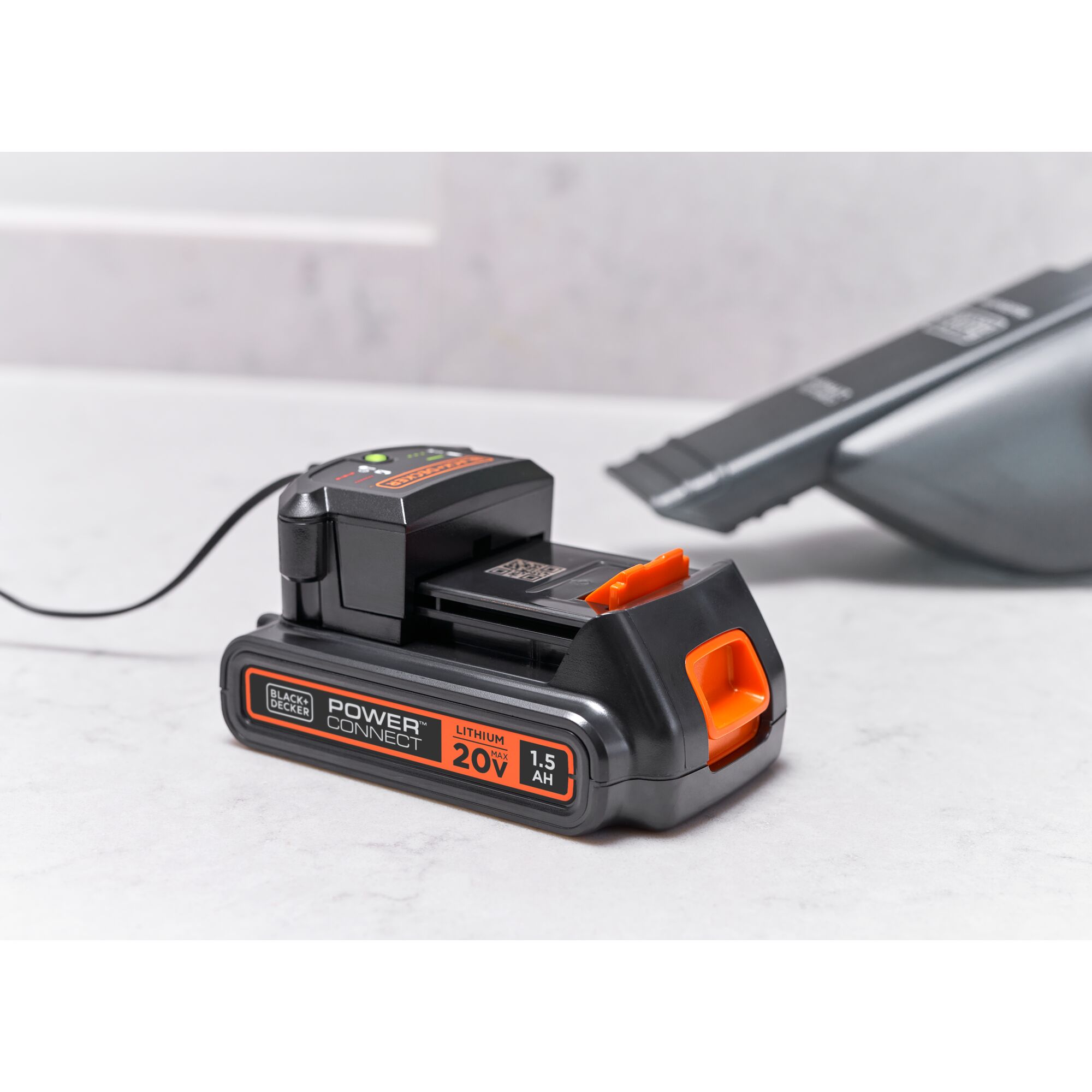 BLACKDECKER BCHV001D1E lithium 20V 1.5Ah battery on white surface, charging with Power Connect charger.