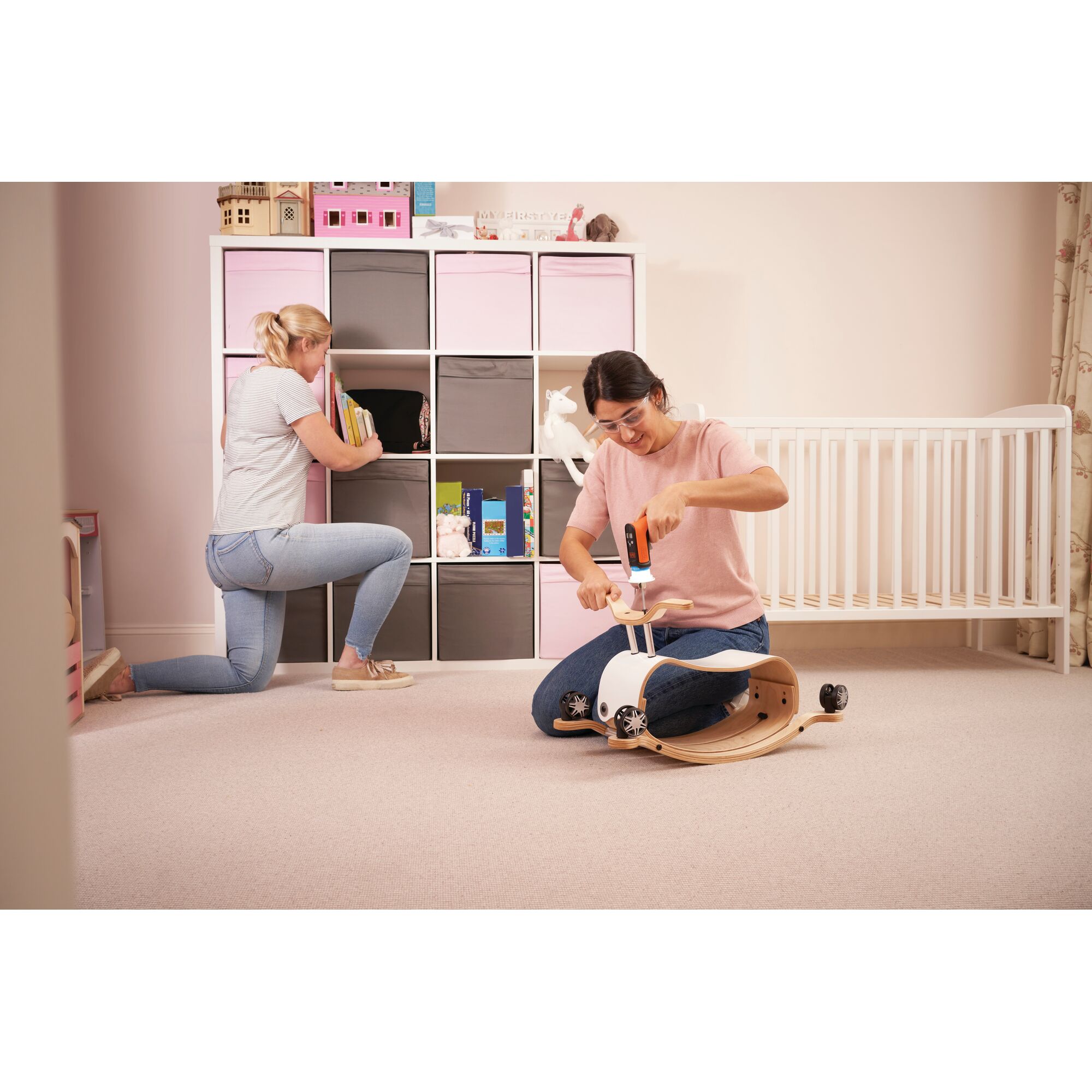 BLACKDECKER BCRTA601 cordless screwdriver used for assembling a wooden toy in a nursery, side angle.