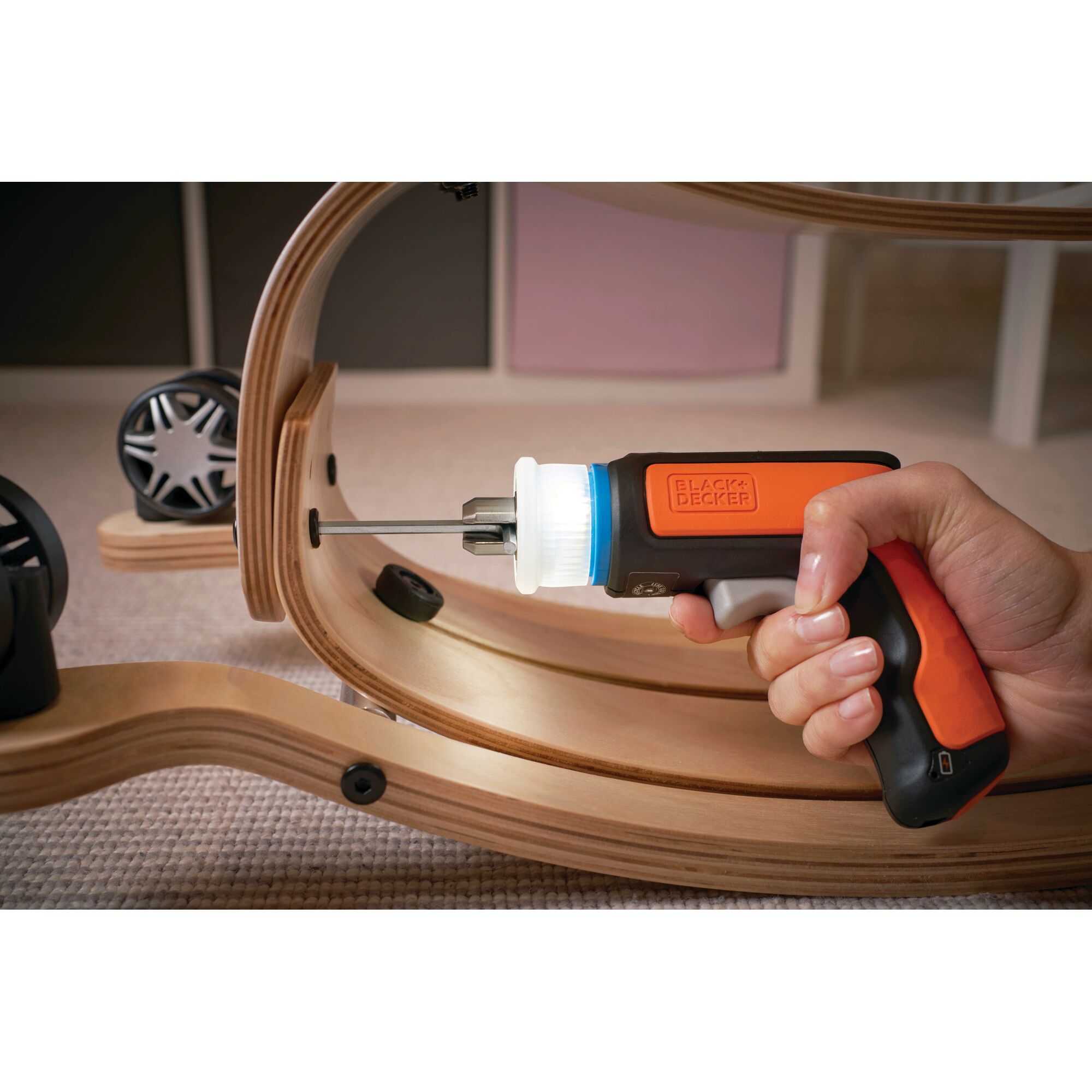 Photo of BLACKDECKER BCRTA601 cordless screwdriver being used to assemble wooden furniture.