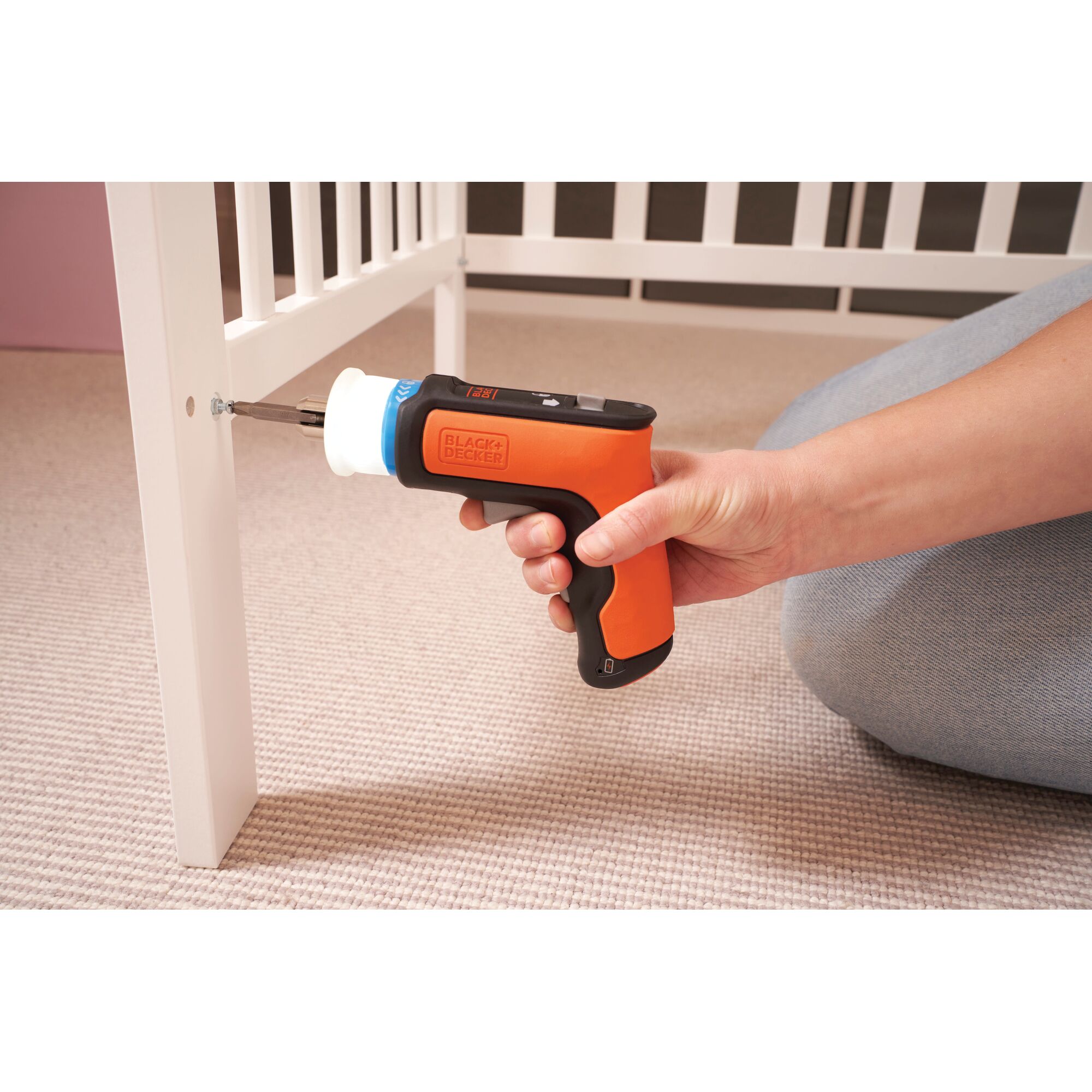 BLACKDECKER BCRTA601 orange cordless screwdriver used to assemble white furniture.