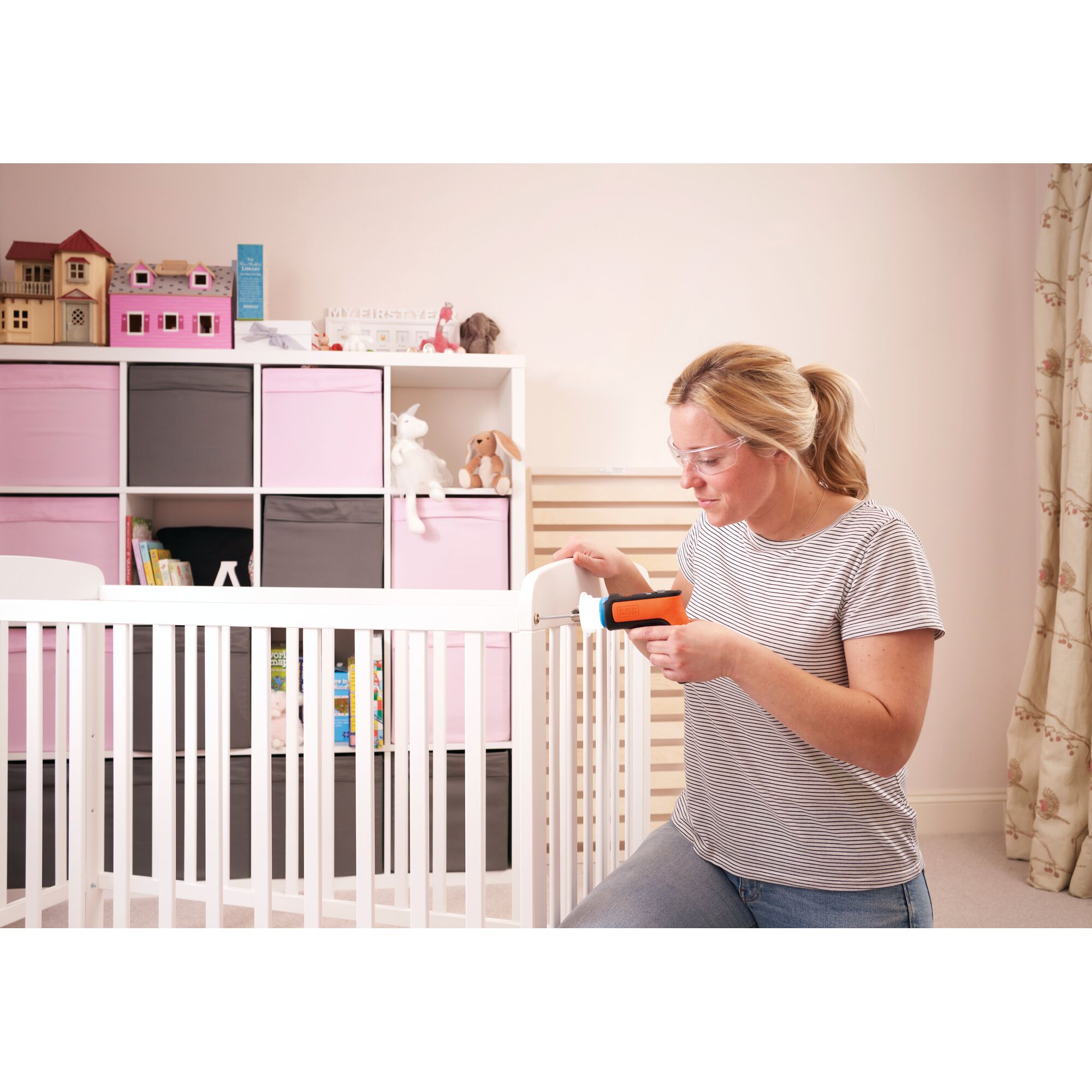 BLACKDECKER BCRTA601 cordless screwdriver used to assemble white crib in nursery room.