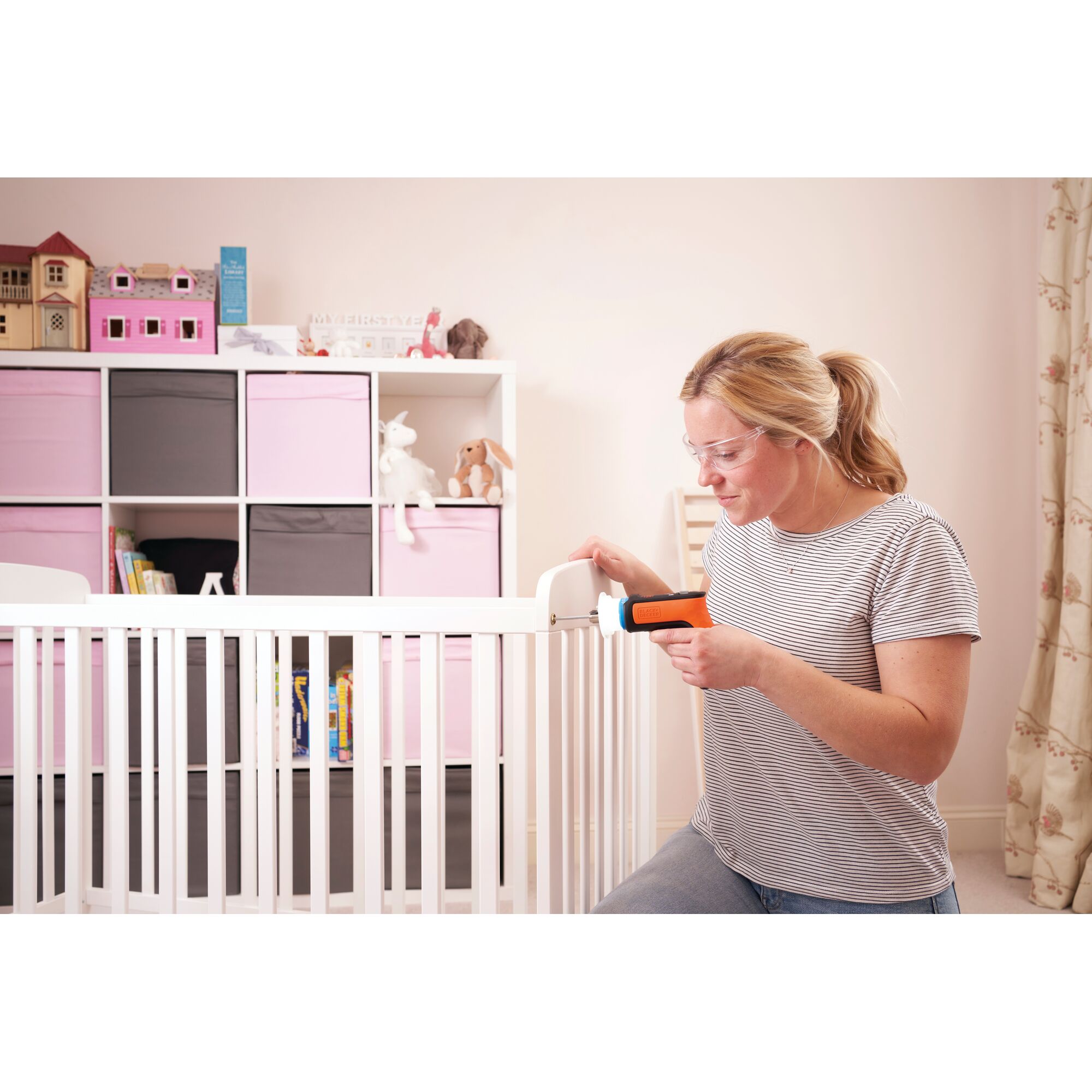 BLACKDECKER BCRTA601 cordless screwdriver used assembling a white crib in a nursery setting.