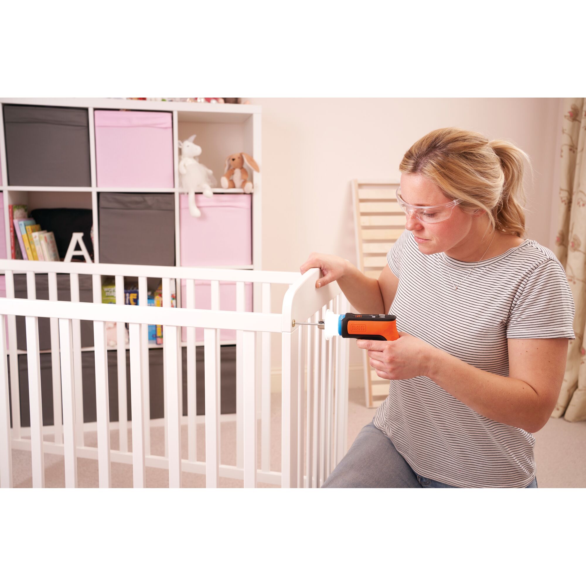 Photo of BLACKDECKER BCRTA601 screwdriver in use assembling a white crib in a nursery.