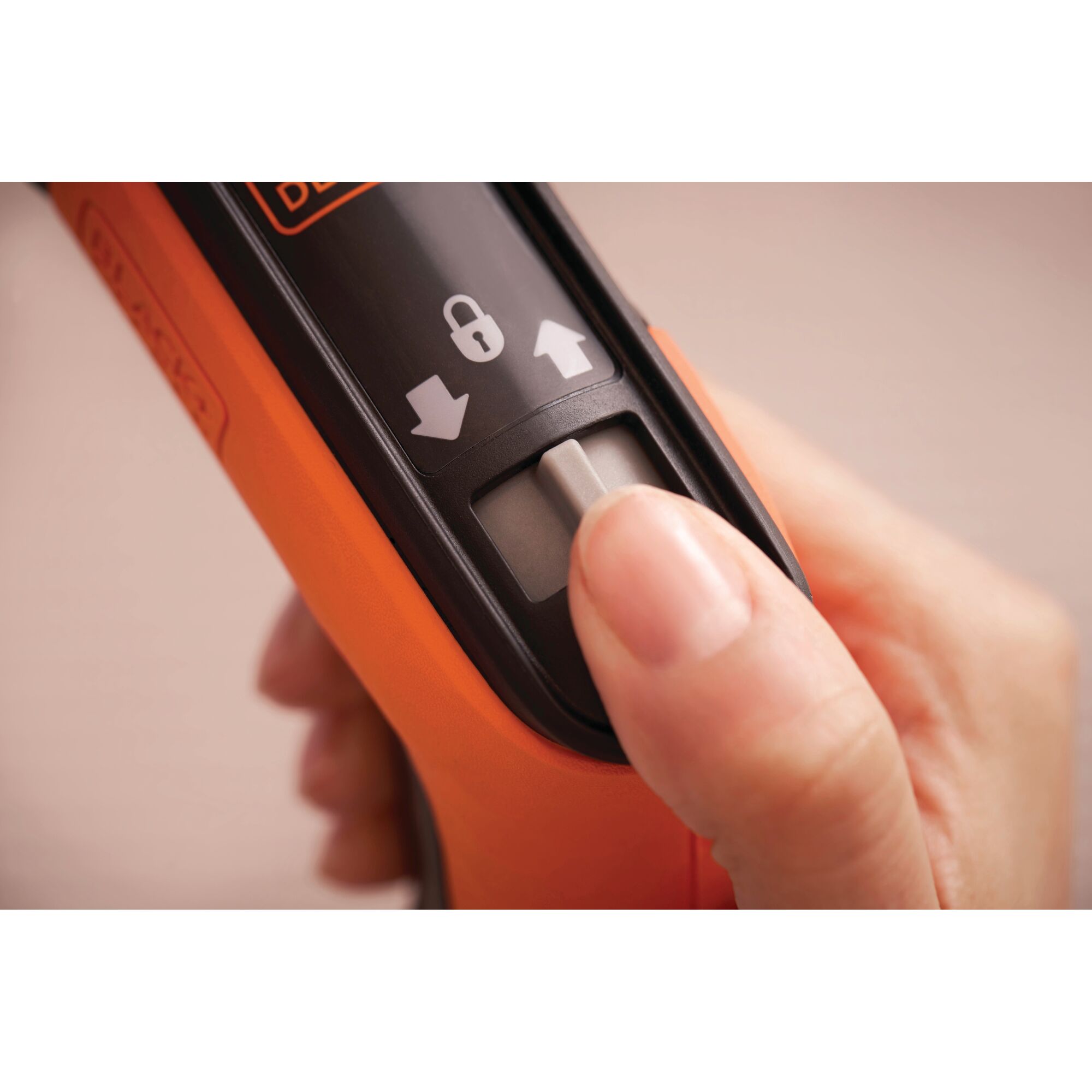 Photo of BLACKDECKER BCRTA601 orange tool switch with lock symbol, close-up view.
