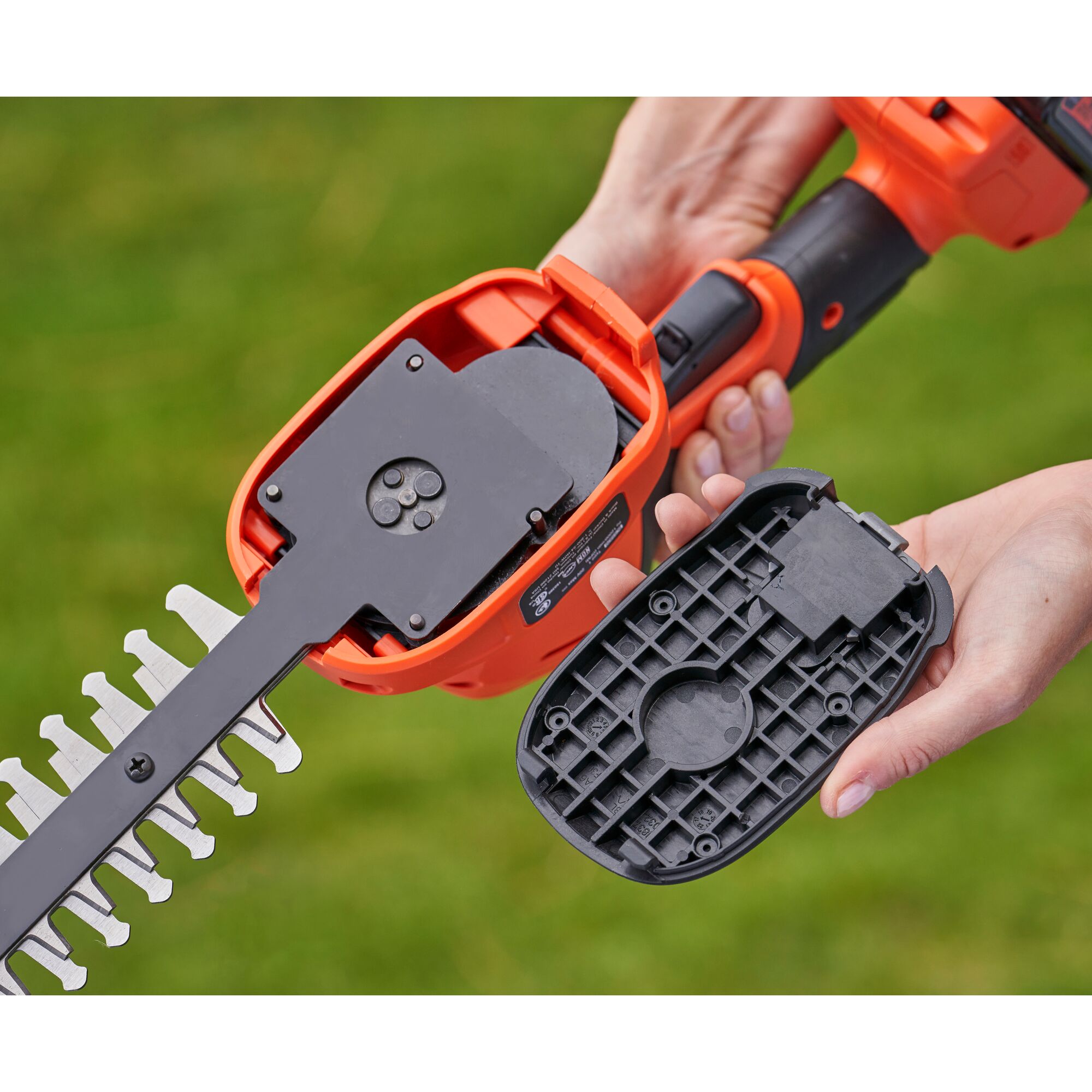 BLACKDECKER BCSS18D1 cordless shrub shear with open blade housing, close-up, outdoors.