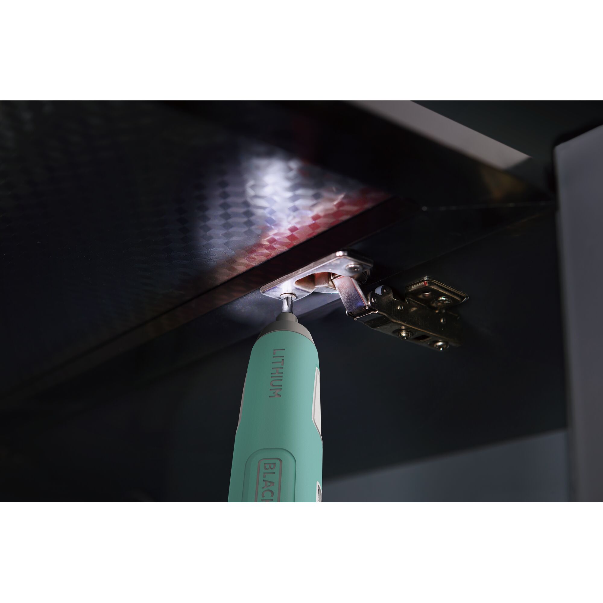 BLACKDECKER BD40K27B cordless screwdriver tightening a hinge screw under a cabinet.