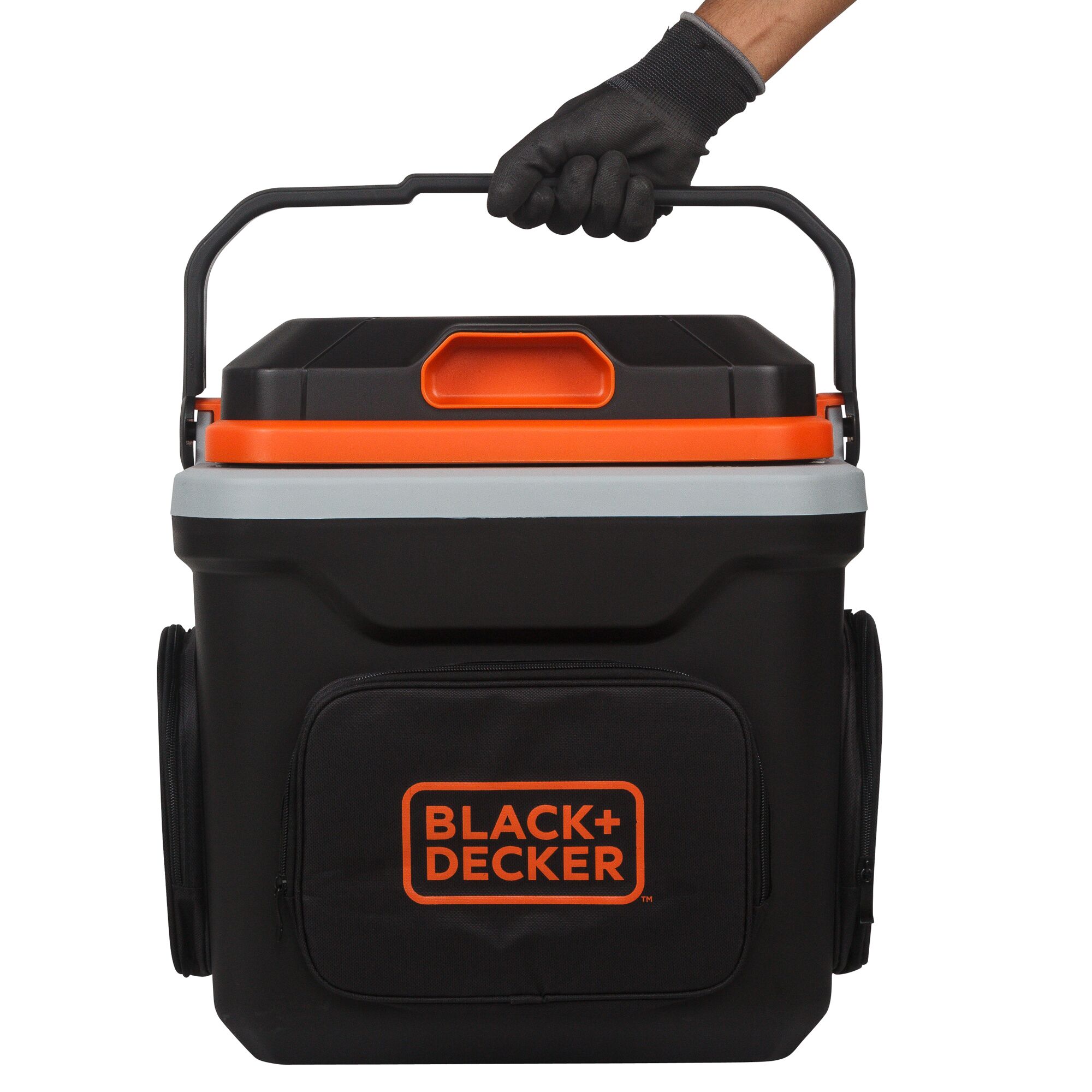 Front view of BLACK+DECKER BDC24L black portable cooler with orange accents and fabric front pocket, handle held by gloved hand.