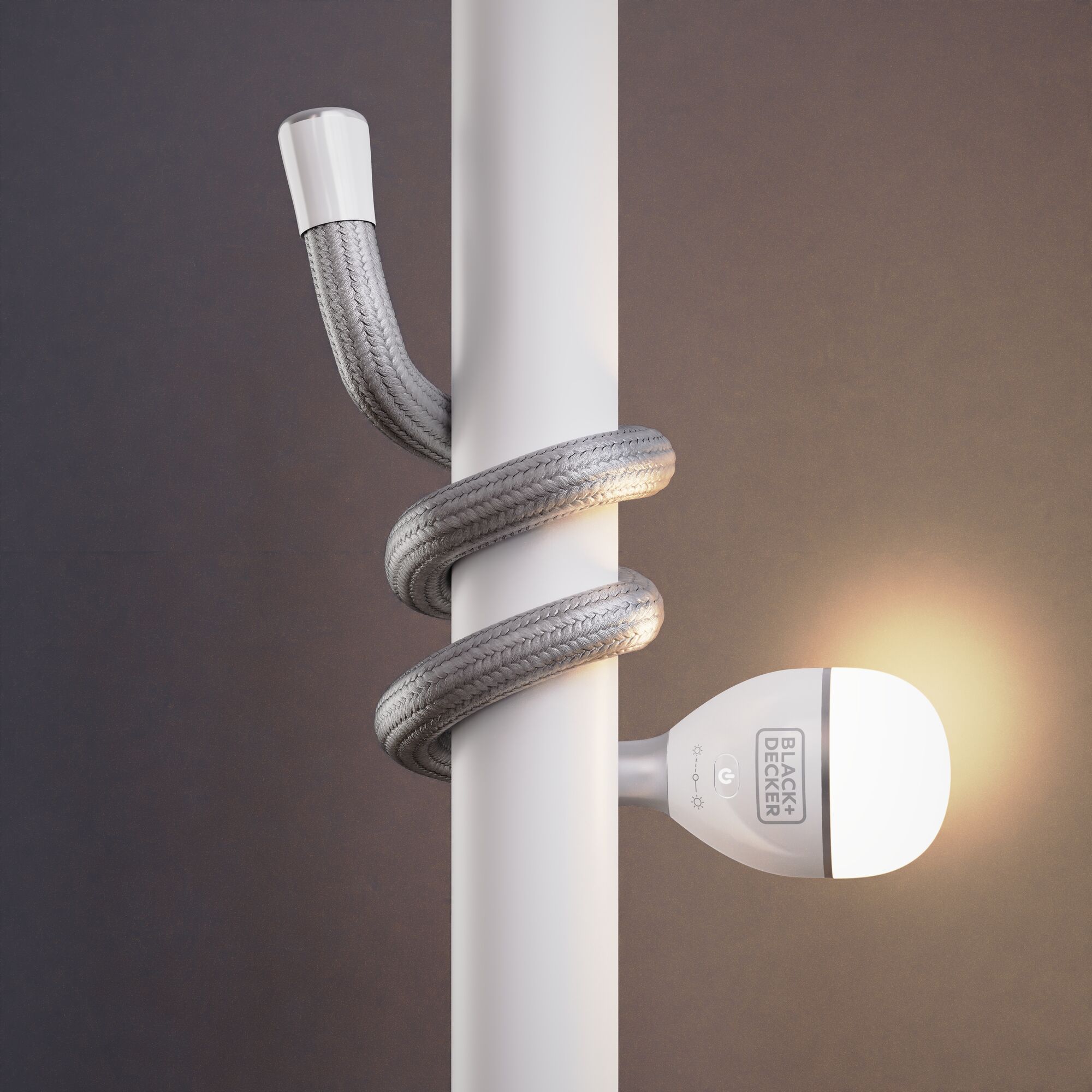 BLACK+DECKER BDCFSL01 flexible LED lamp wrapped around a white pole, lit bulb, side view.