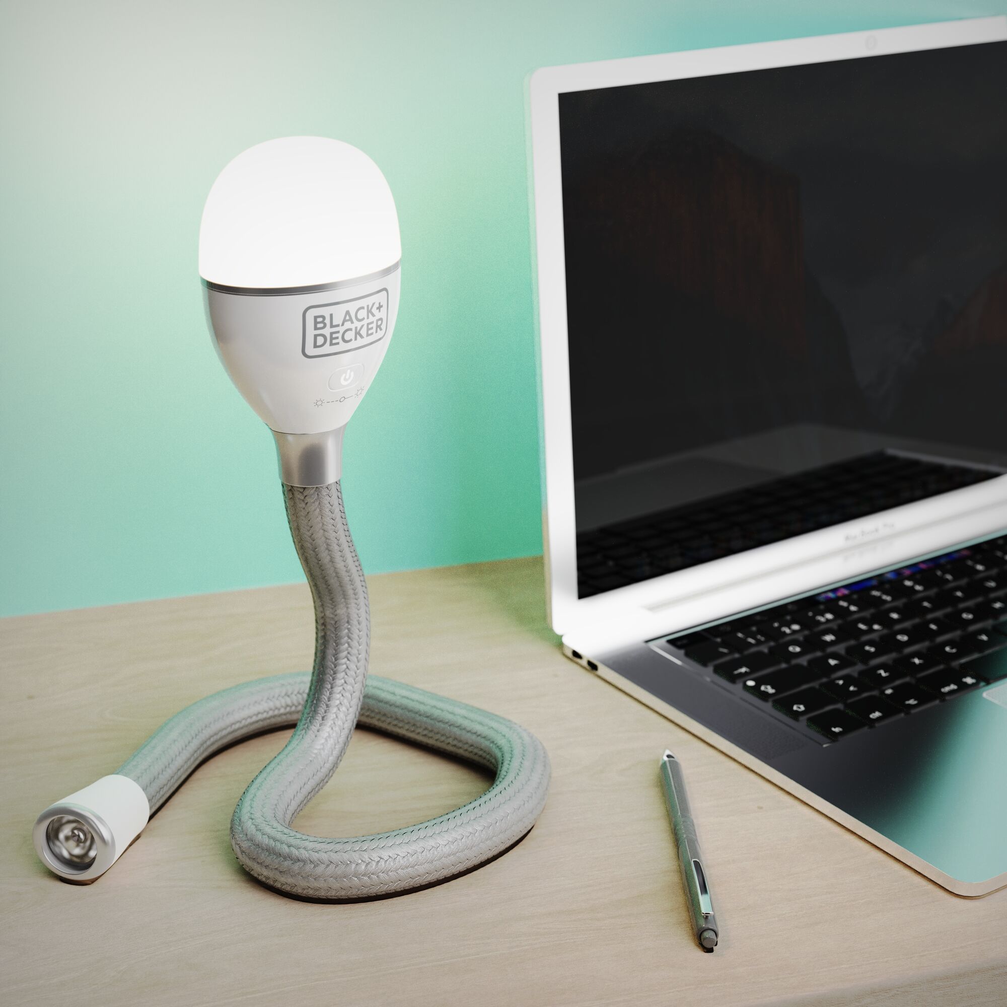 BLACK+DECKER BDCFSL01 flexible LED desk lamp on wood surface beside laptop and pen.
