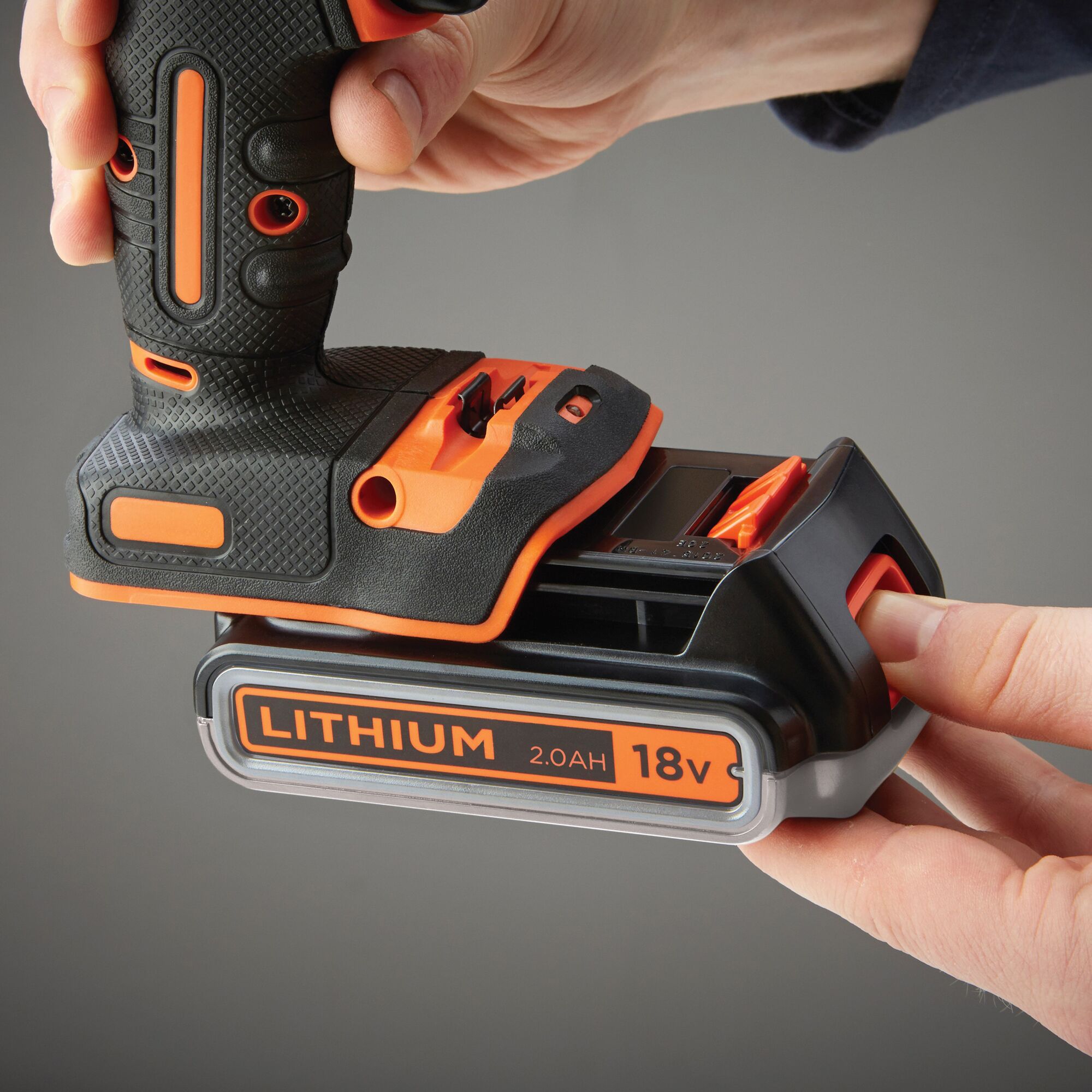 BLACKDECKER BDCHD18K1B cordless drill with 18V 2.0Ah lithium battery being inserted, close-up angle.