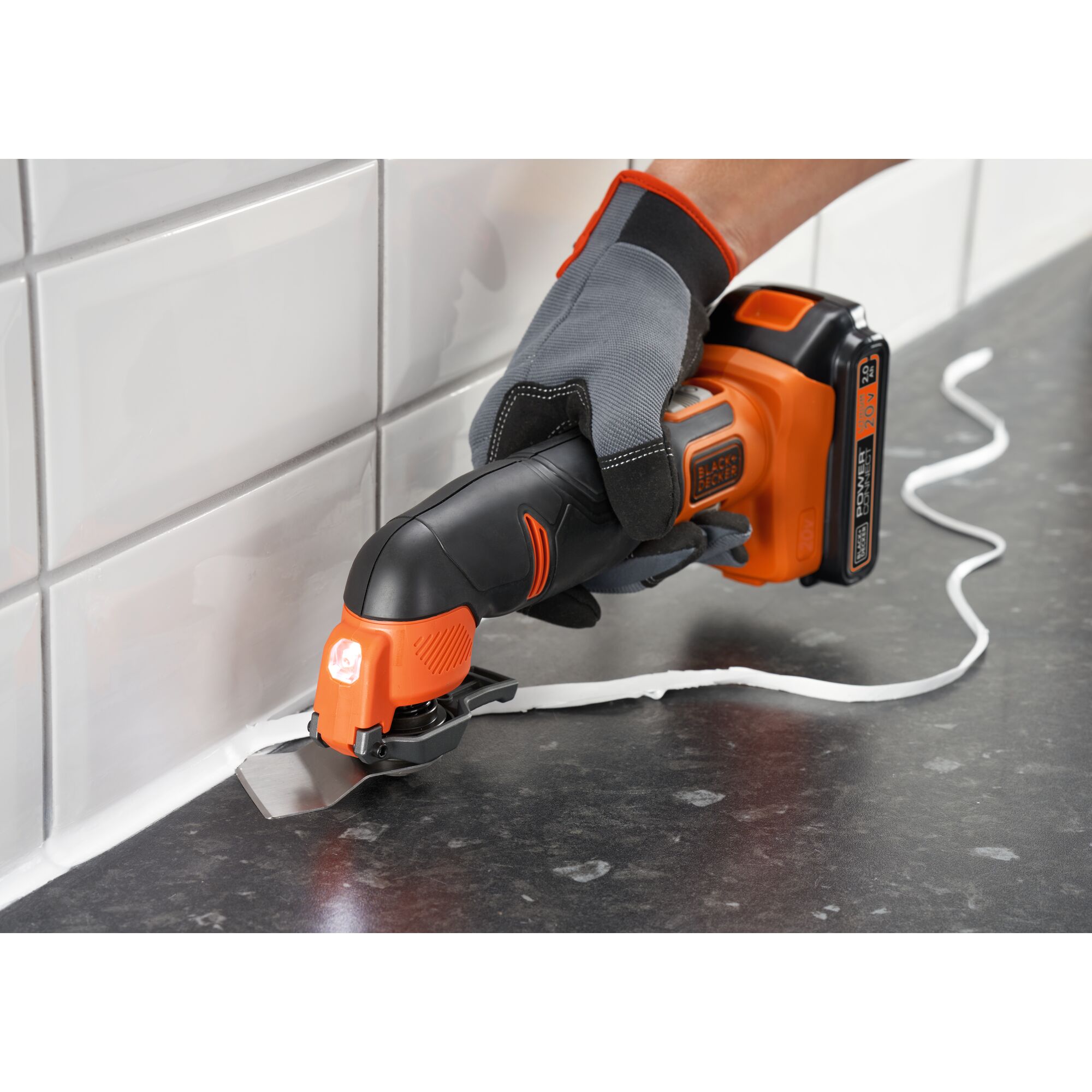 Photo of BLACKDECKER BDCOS18D1K oscillating tool used to remove sealant from kitchen tiles.