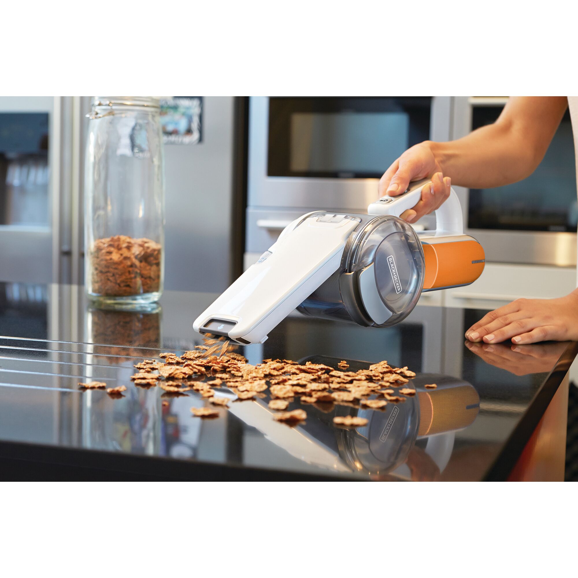 BLACKDECKER BDH1020OAC handheld vacuum cleaning cereal on kitchen counter.