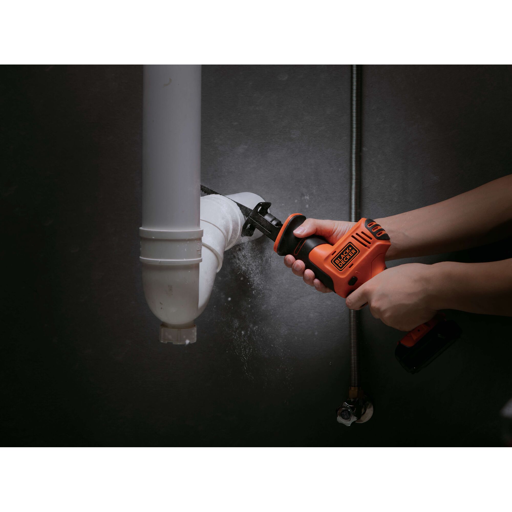 Photo of BLACKDECKER BDR12K cordless reciprocating saw cutting white PVC pipe indoors.