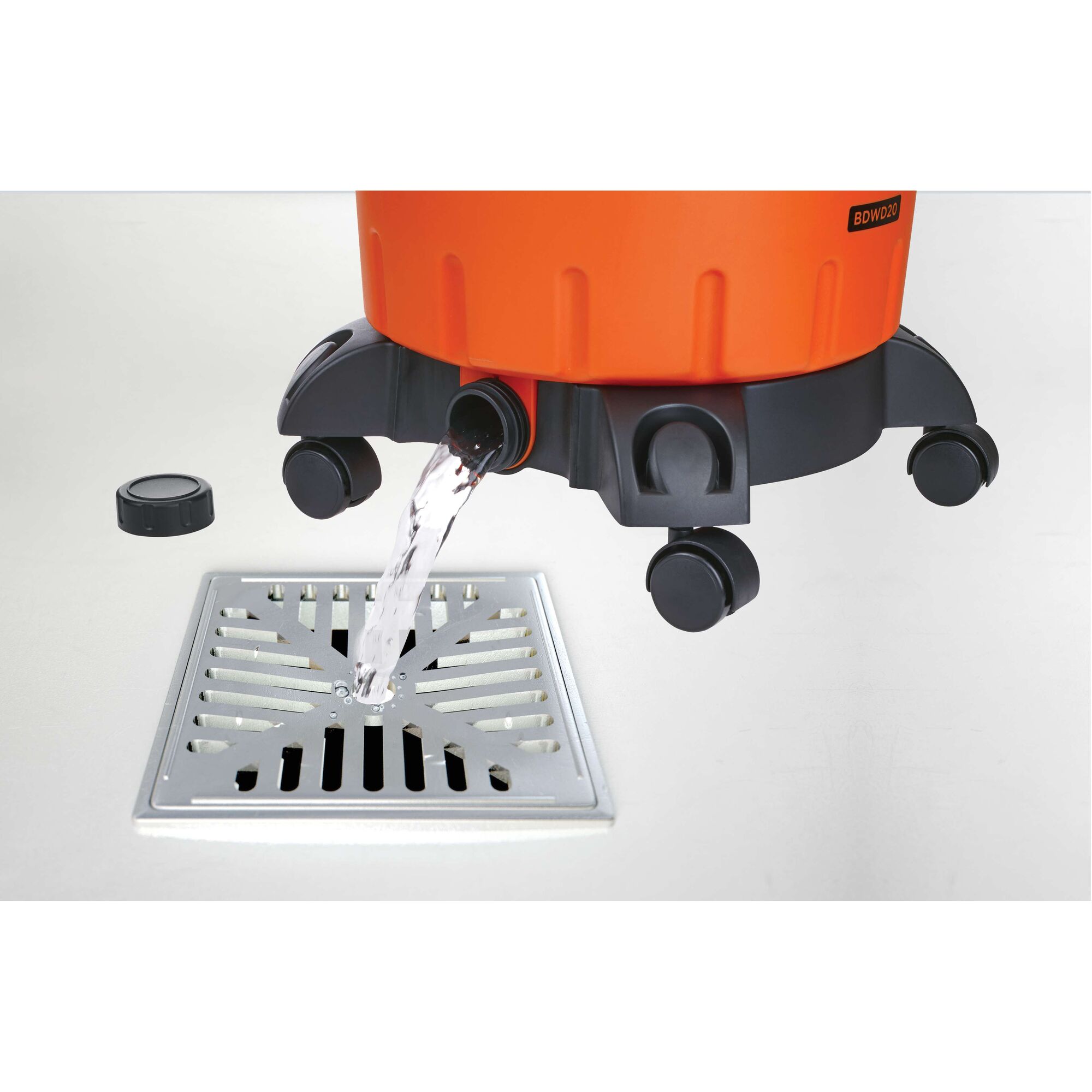 BLACKDECKER BDWD15 wet dry vacuum base draining water from spout into floor drain, side angle.
