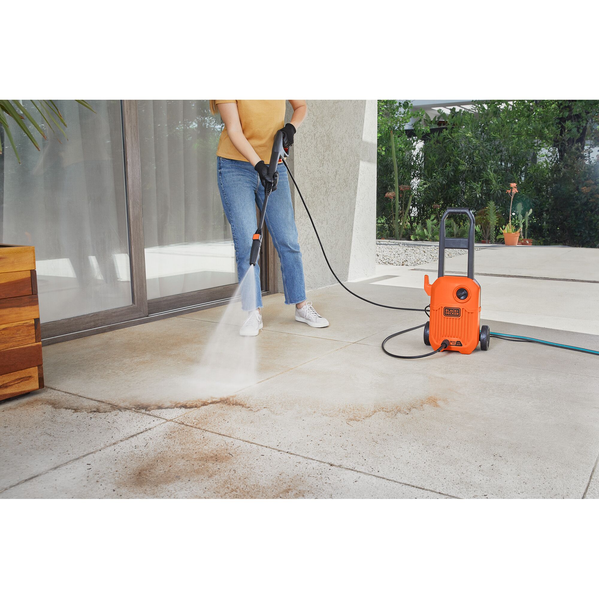 BLACKDECKER BEPW1600L pressure washer cleaning outdoor patio tiles with water spray