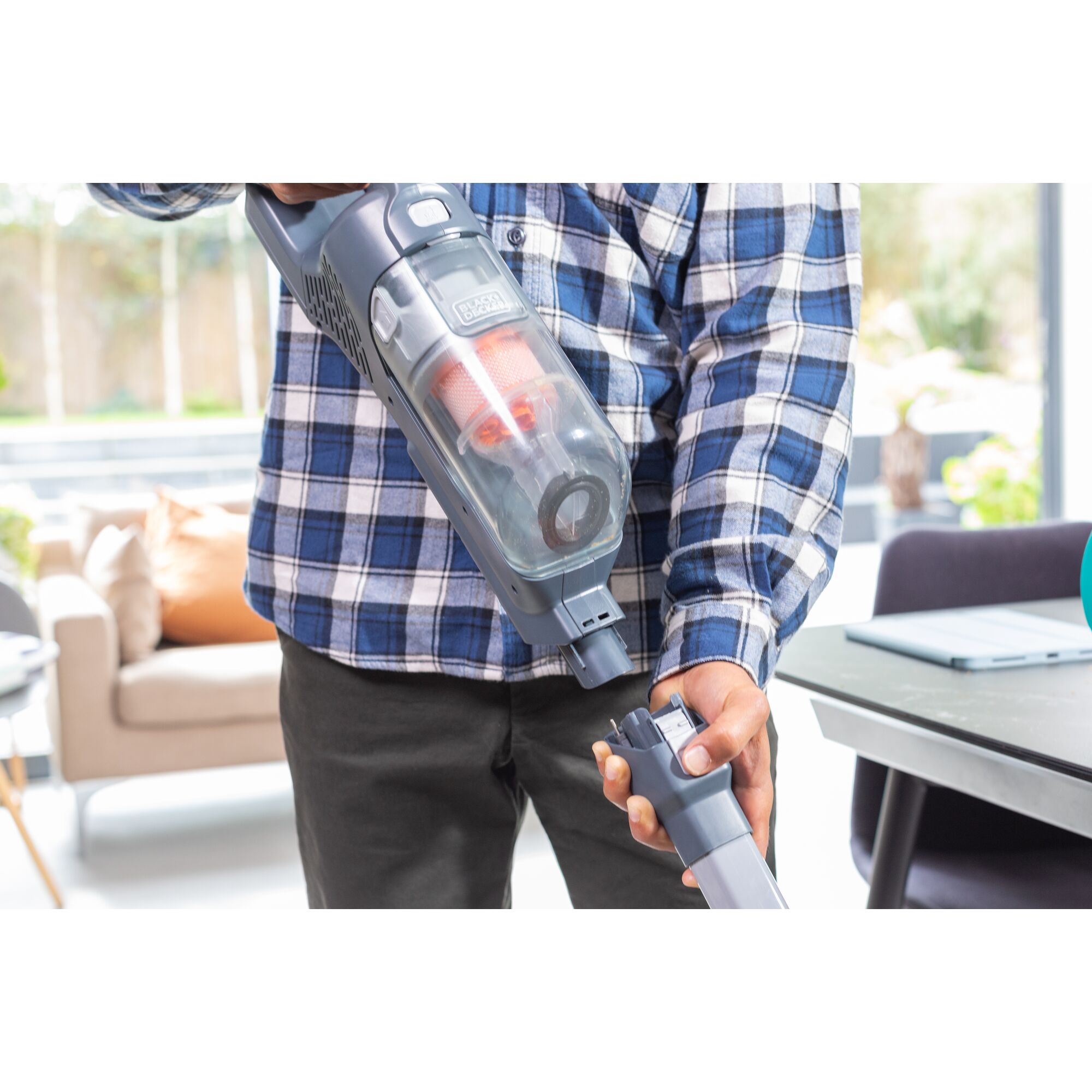 Photo of BLACKDECKER BHFEA520J cordless vacuum being assembled in a modern indoor setting.