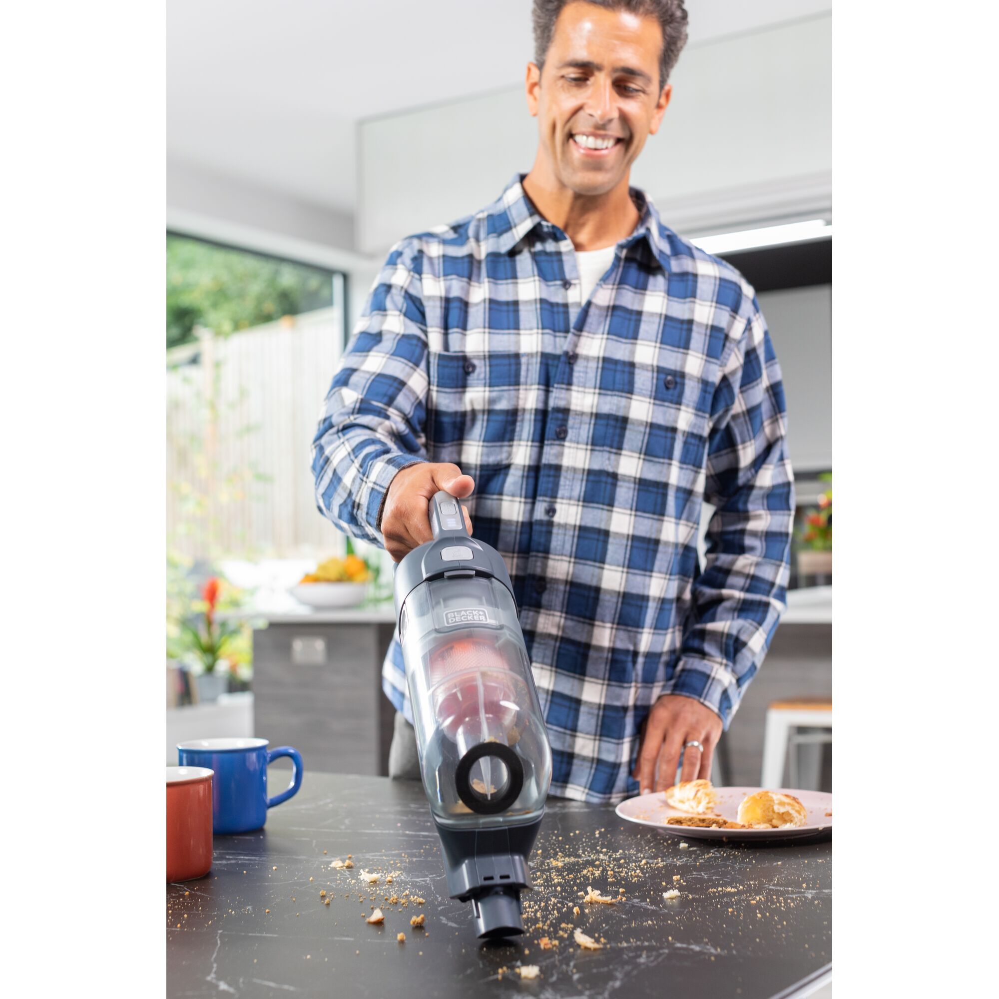 BLACKDECKER BHFEA520J handheld vacuum cleaning countertop crumbs in kitchen.