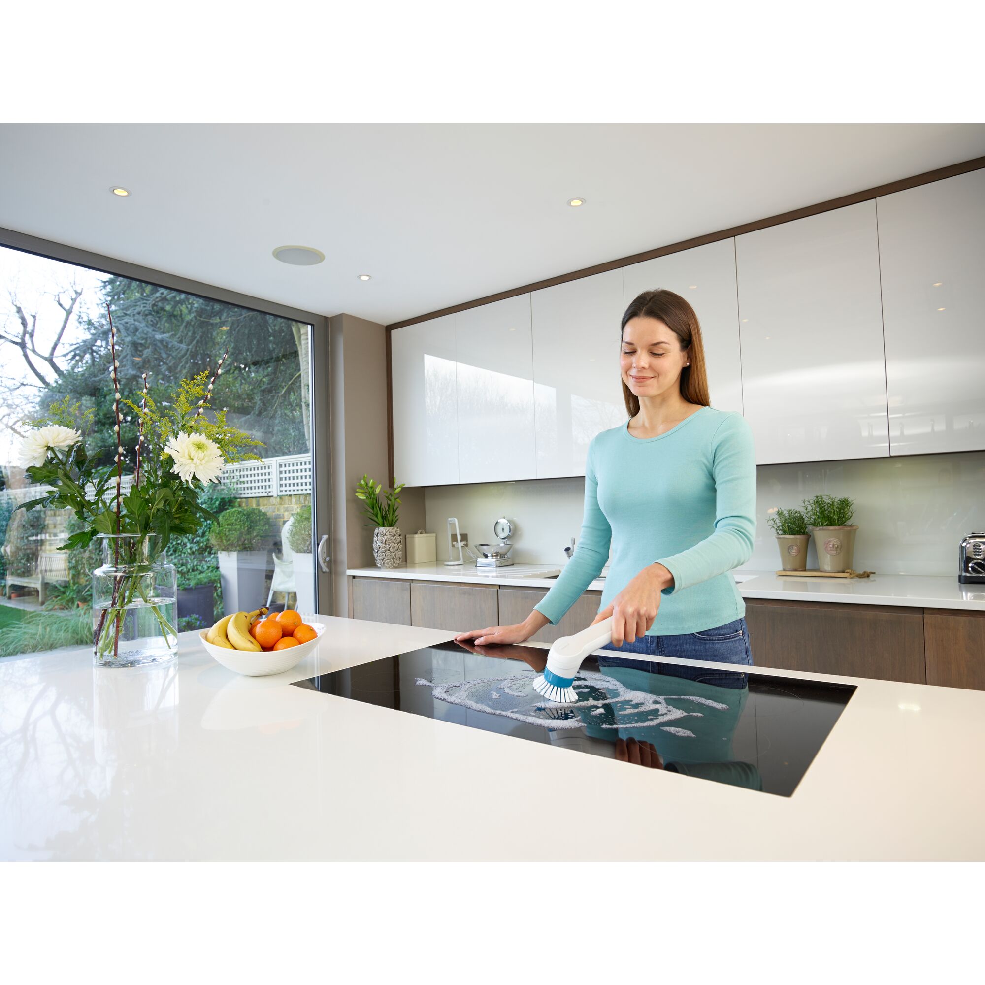 BLACKDECKER BHPC110 power scrubber cleaning stovetop in modern kitchen.