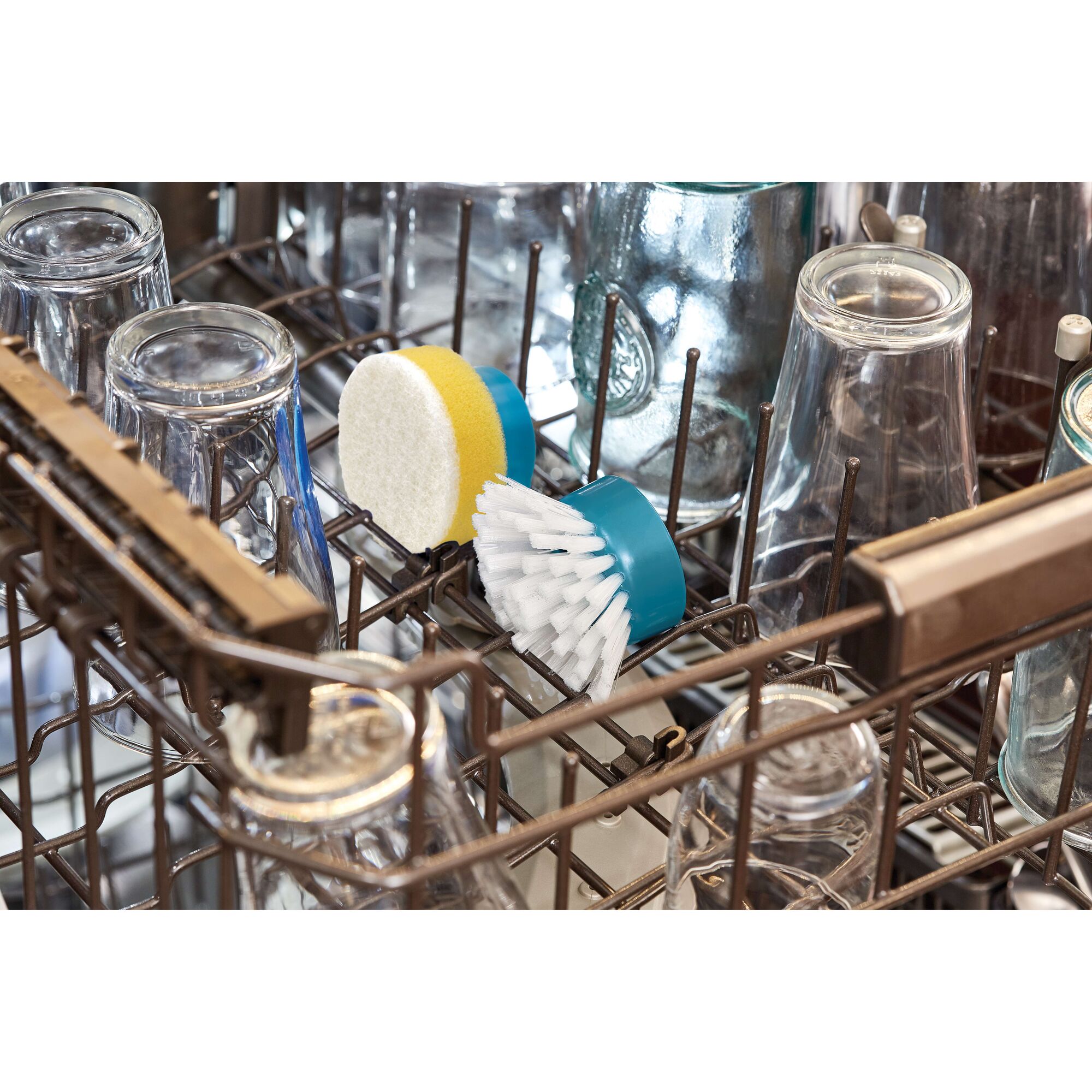 BLACKDECKER BHPC110 cleaning brush and sponge head in dishwasher rack with glassware, front angle.