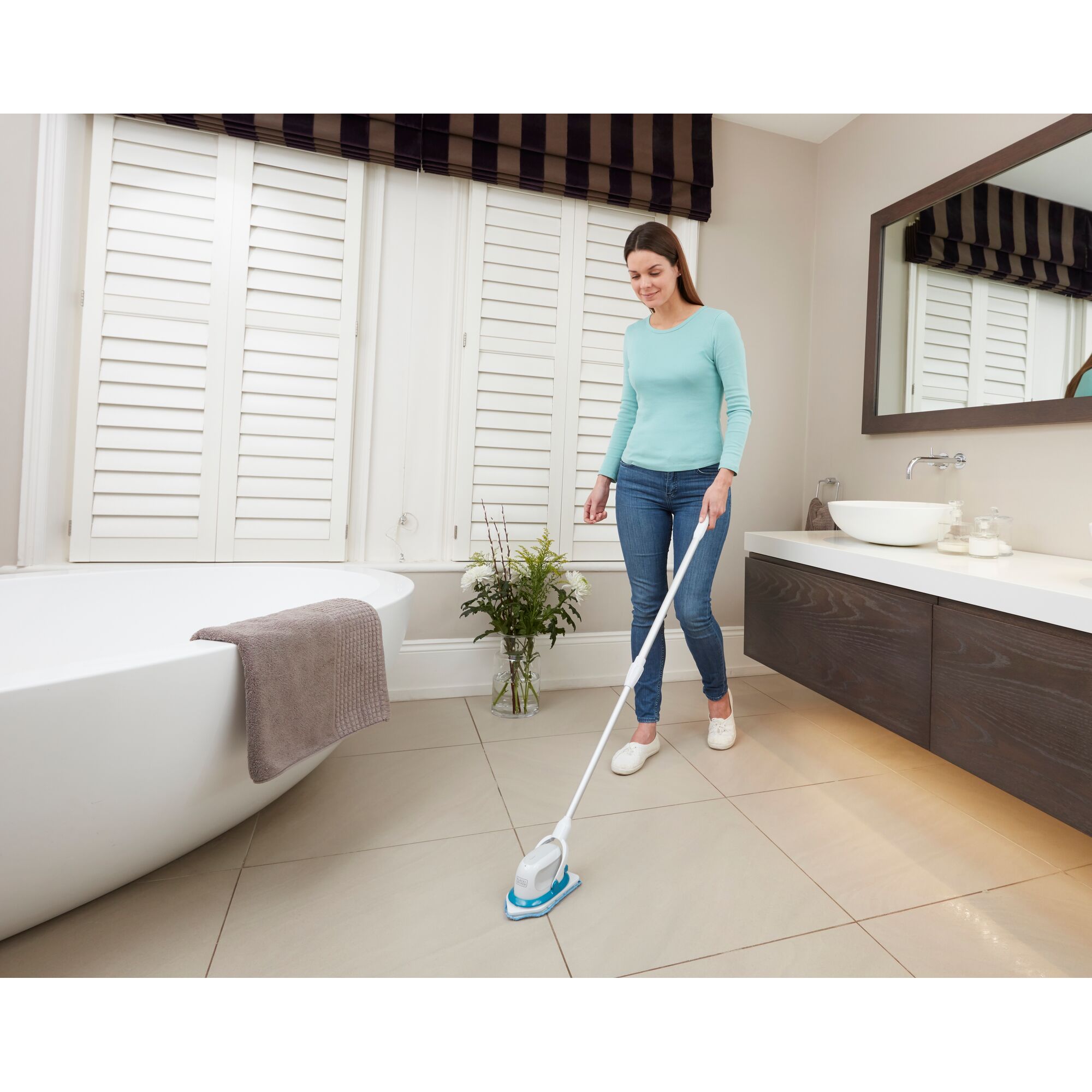 BLACKDECKER BHPC220 handheld power scrubber in use cleaning bathroom floor tiles