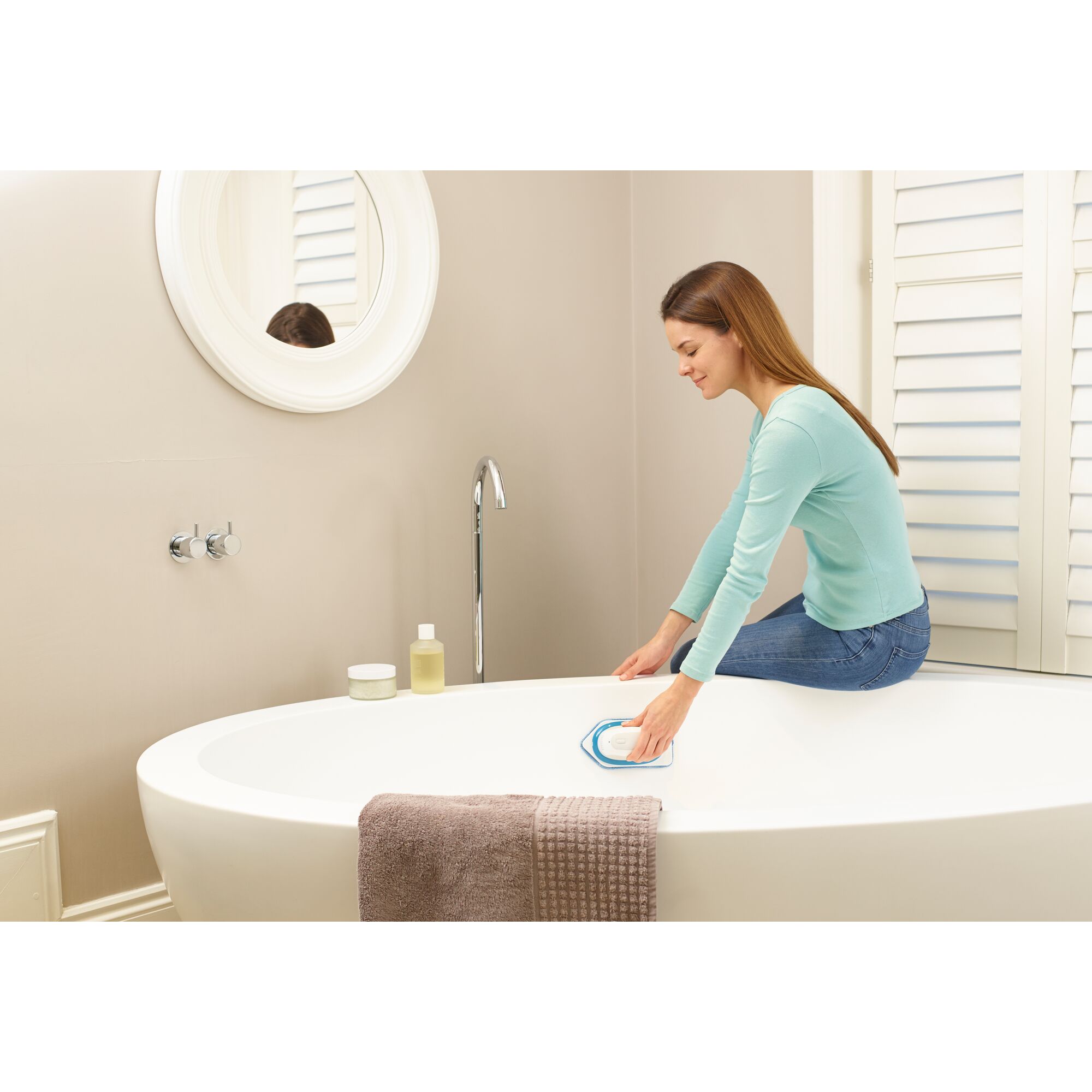 Photo of BLACKDECKER BHPC220 handheld cleaning tool used on a white bathtub in a modern bathroom.