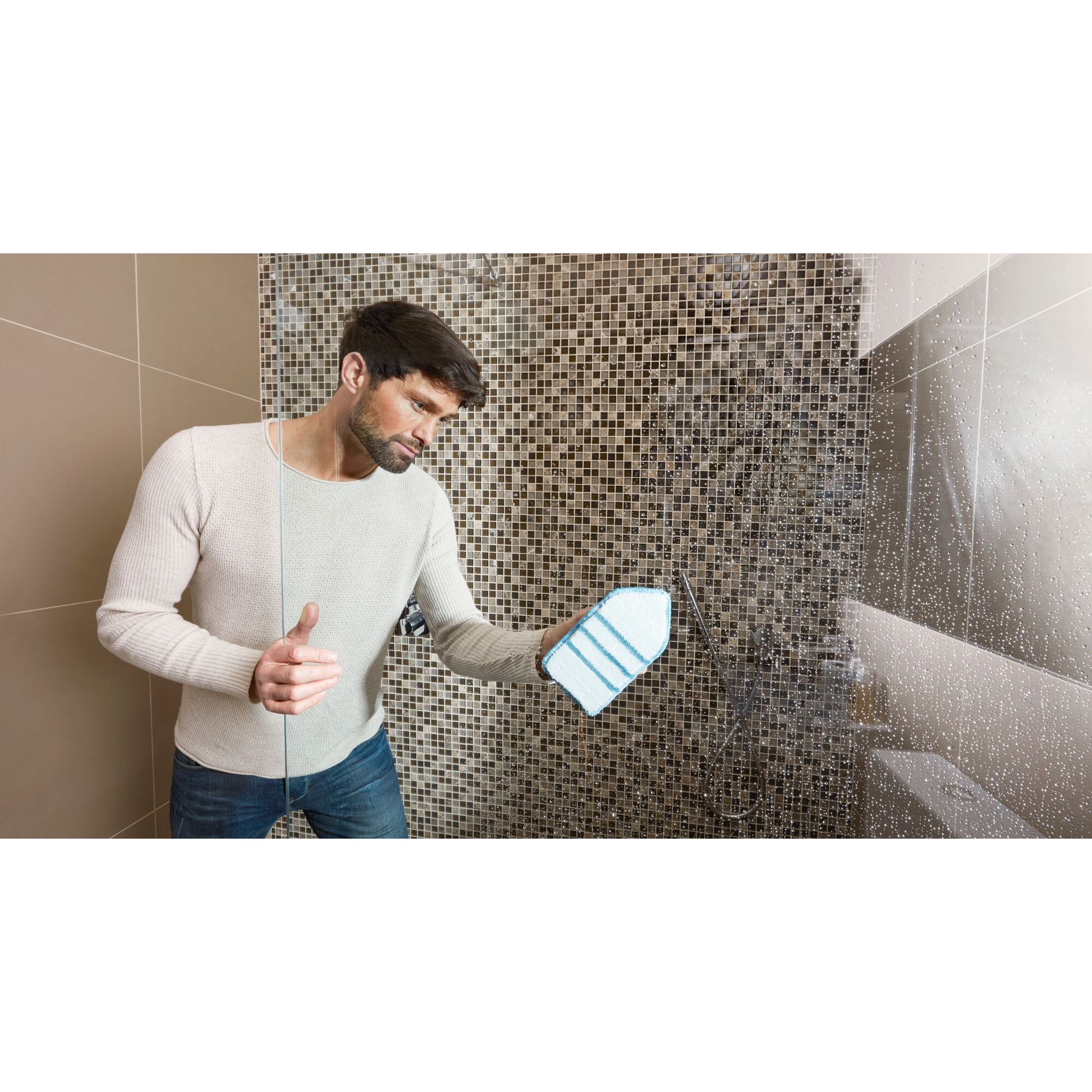 BLACKDECKER BHPC220 handheld cleaning tool wiping glass shower door in tiled bathroom.