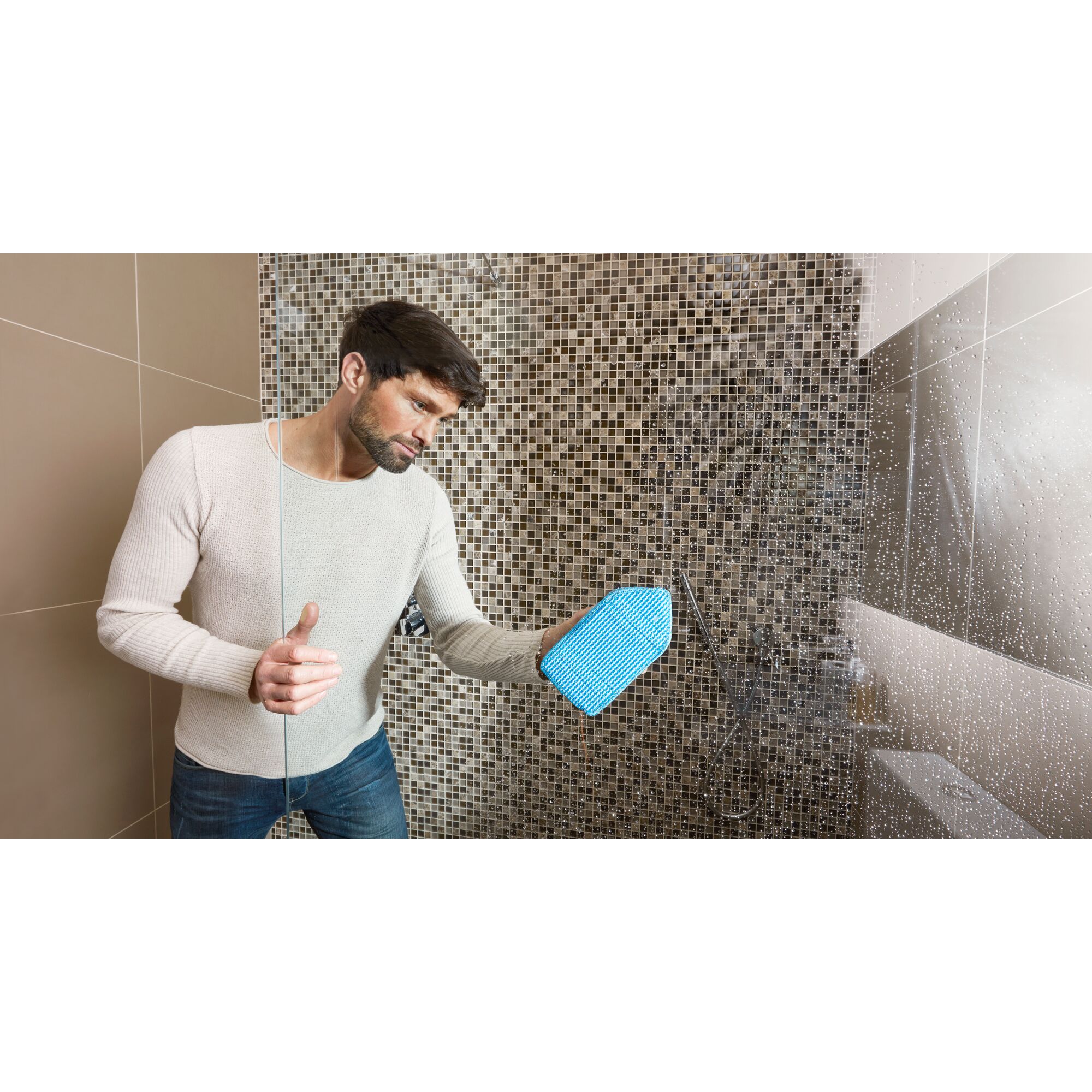BLACKDECKER BHPC220 cleaning mitt in use on shower glass, blue mitt, bathroom tile background, photography.