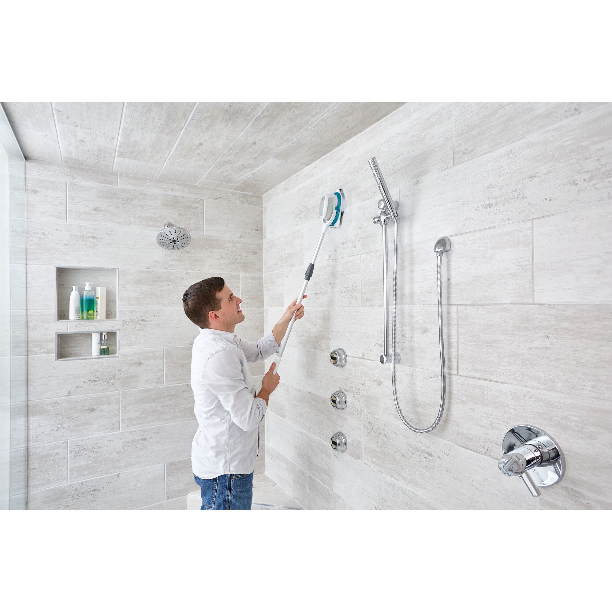 Photo of BLACKDECKER BHPC220 power scrubber being used to clean tiled shower wall.
