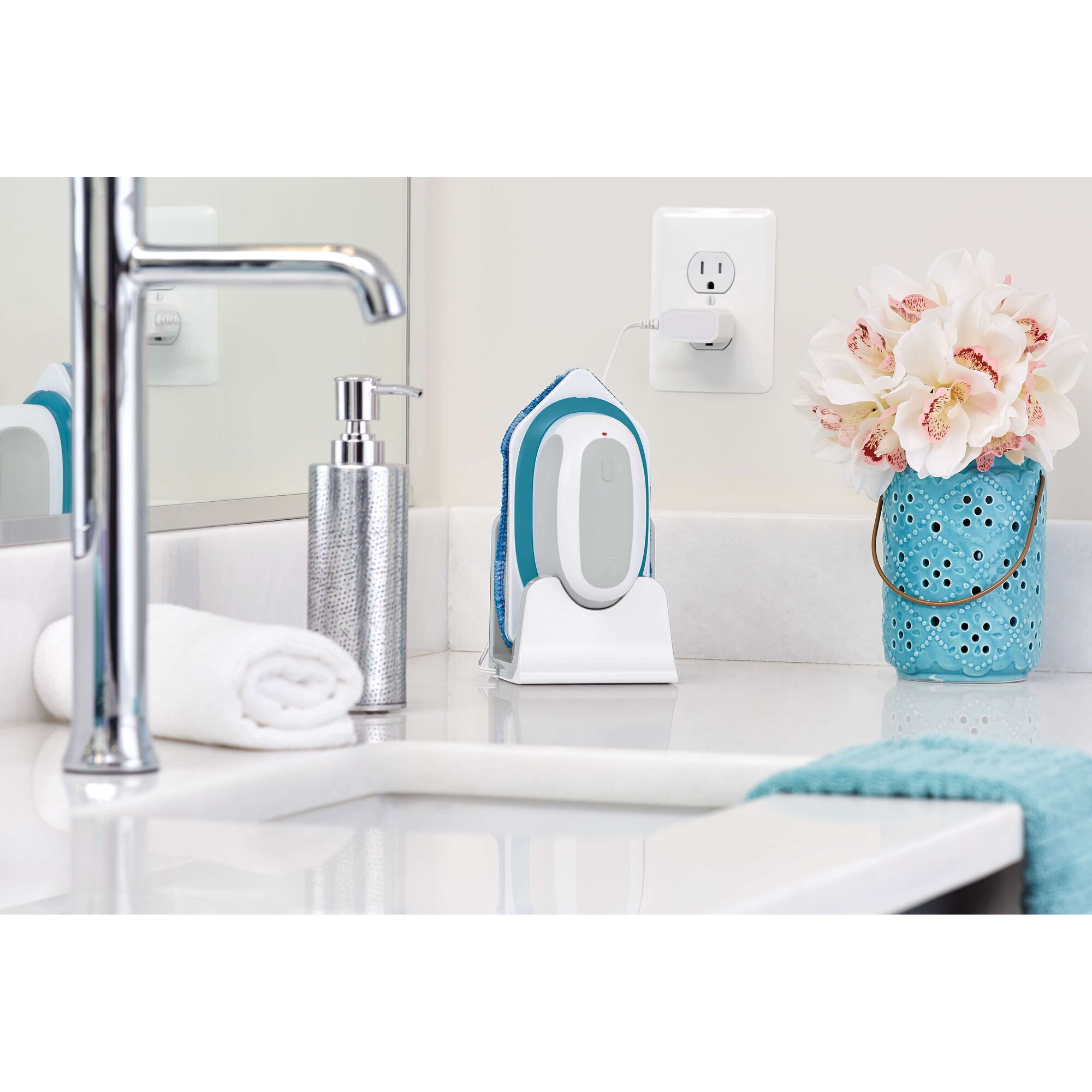 BLACKDECKER BHPC220 handheld fabric steamer in blue, on bathroom counter, charging upright.