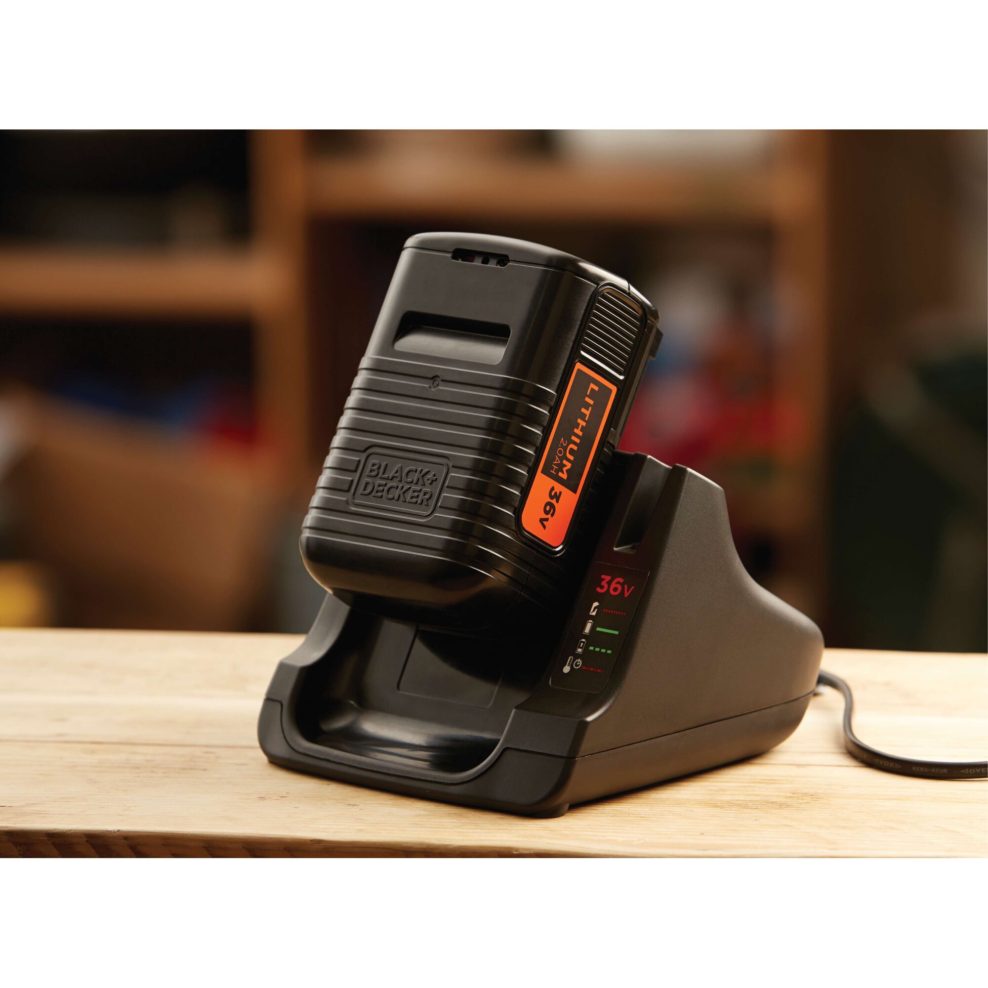 BLACKDECKER BL20362 lithium 36V battery charger, black, close-up on wooden table.