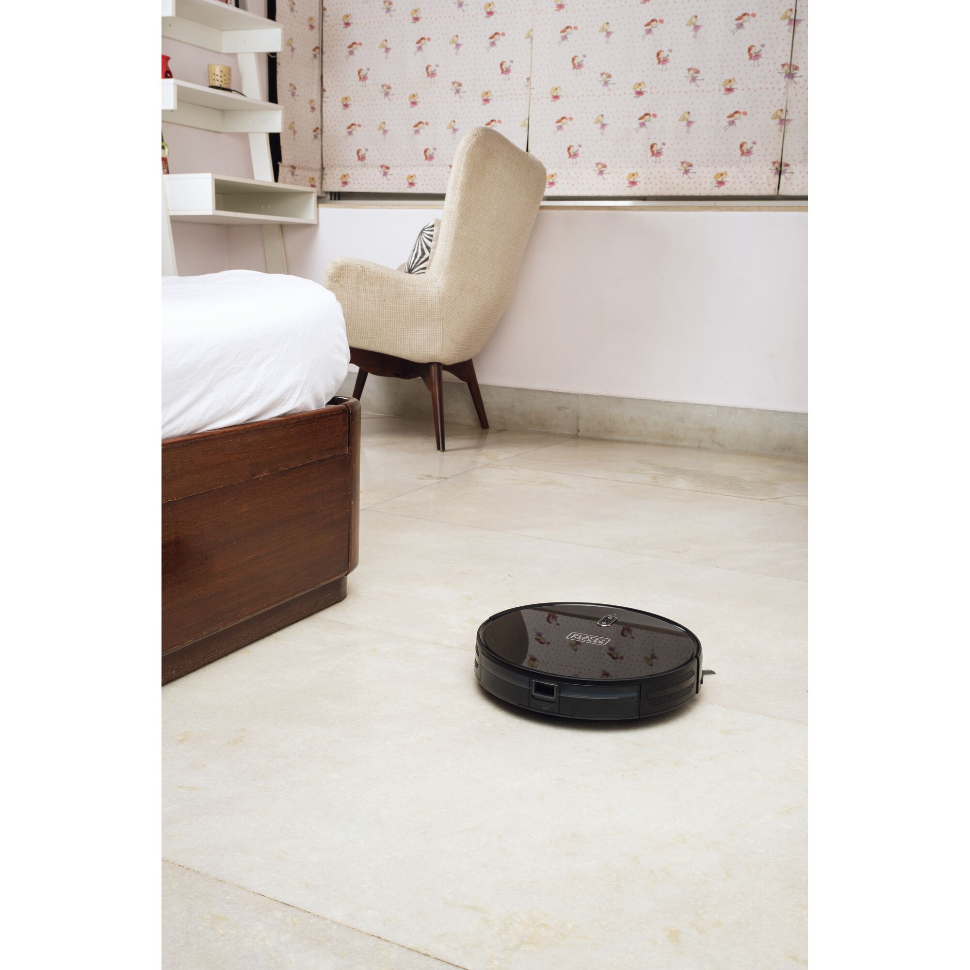 BLACKDECKER BRVA425B00 robot vacuum cleaner operating on tile floor in modern bedroom.