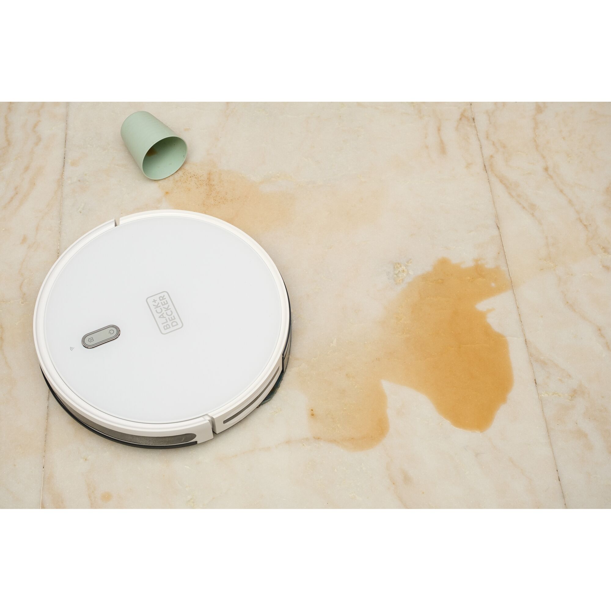 BLACKDECKER BRVA425B10 robot vacuum cleaning spilled liquid on marble floor, top view.