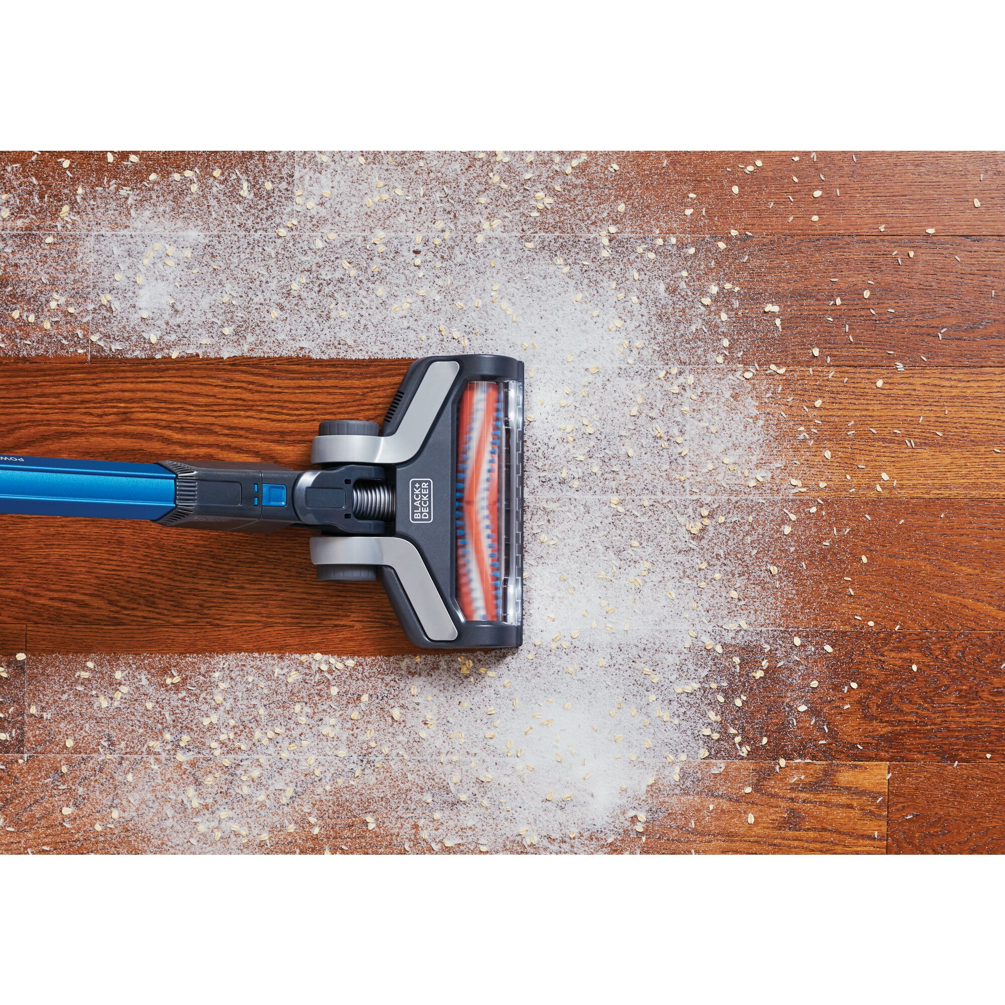 Overhead view of POWERSERIES Extreme Cordless Stick Vacuum Cleaner being used to clean mess from wooden floor.