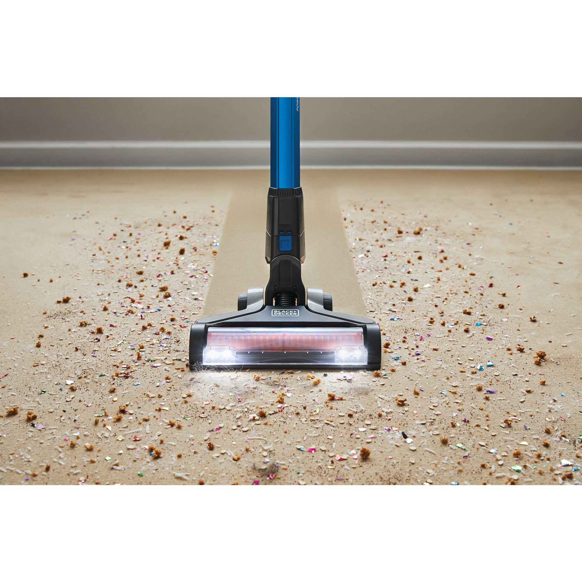 BLACK+DECKER POWERSERIES™ Extreme™ Cordless Stick Vacuum Cleaner cleaning the trash from the carpet.