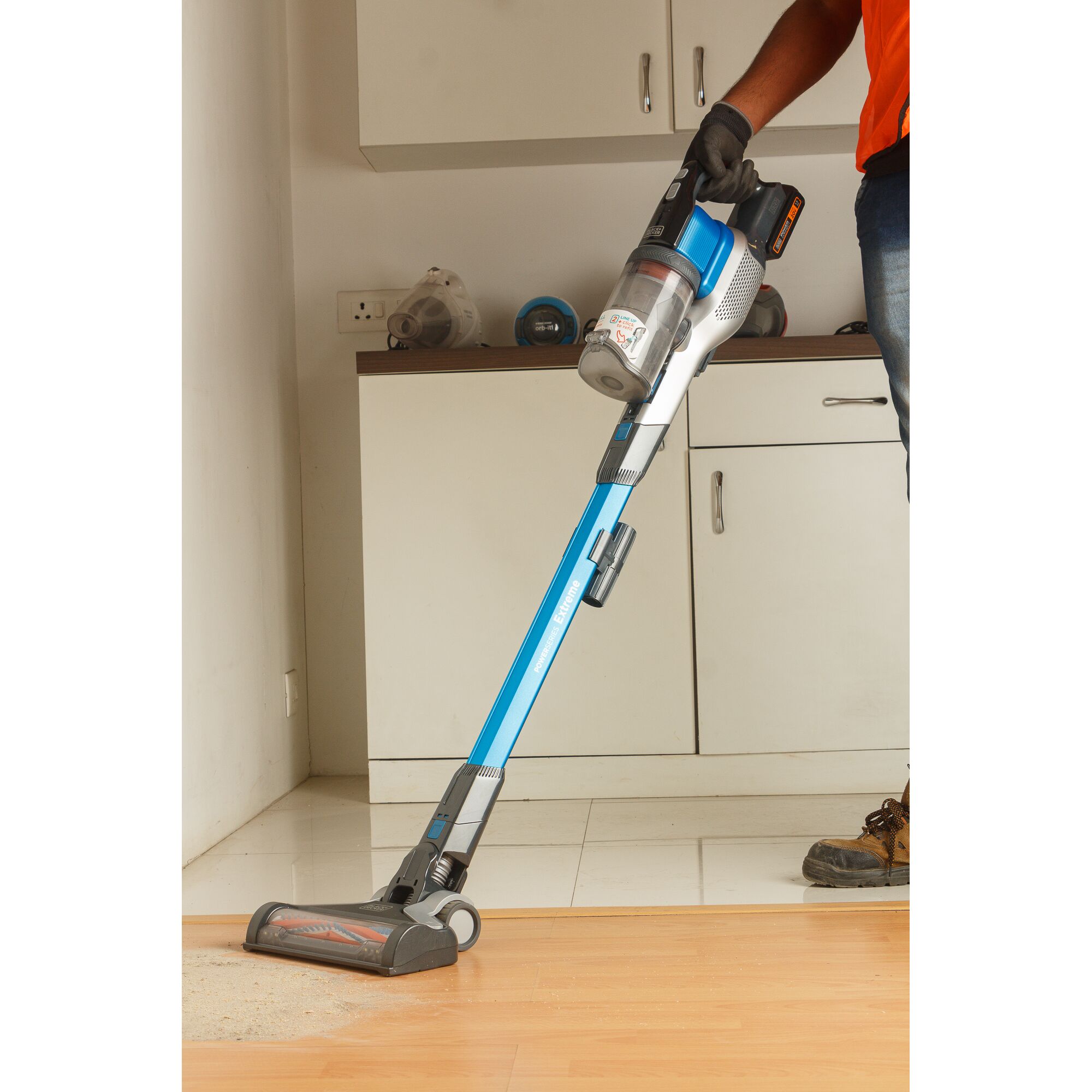 Photo of BLACKDECKER BSV2020G cordless stick vacuum in use cleaning a light-colored floor.