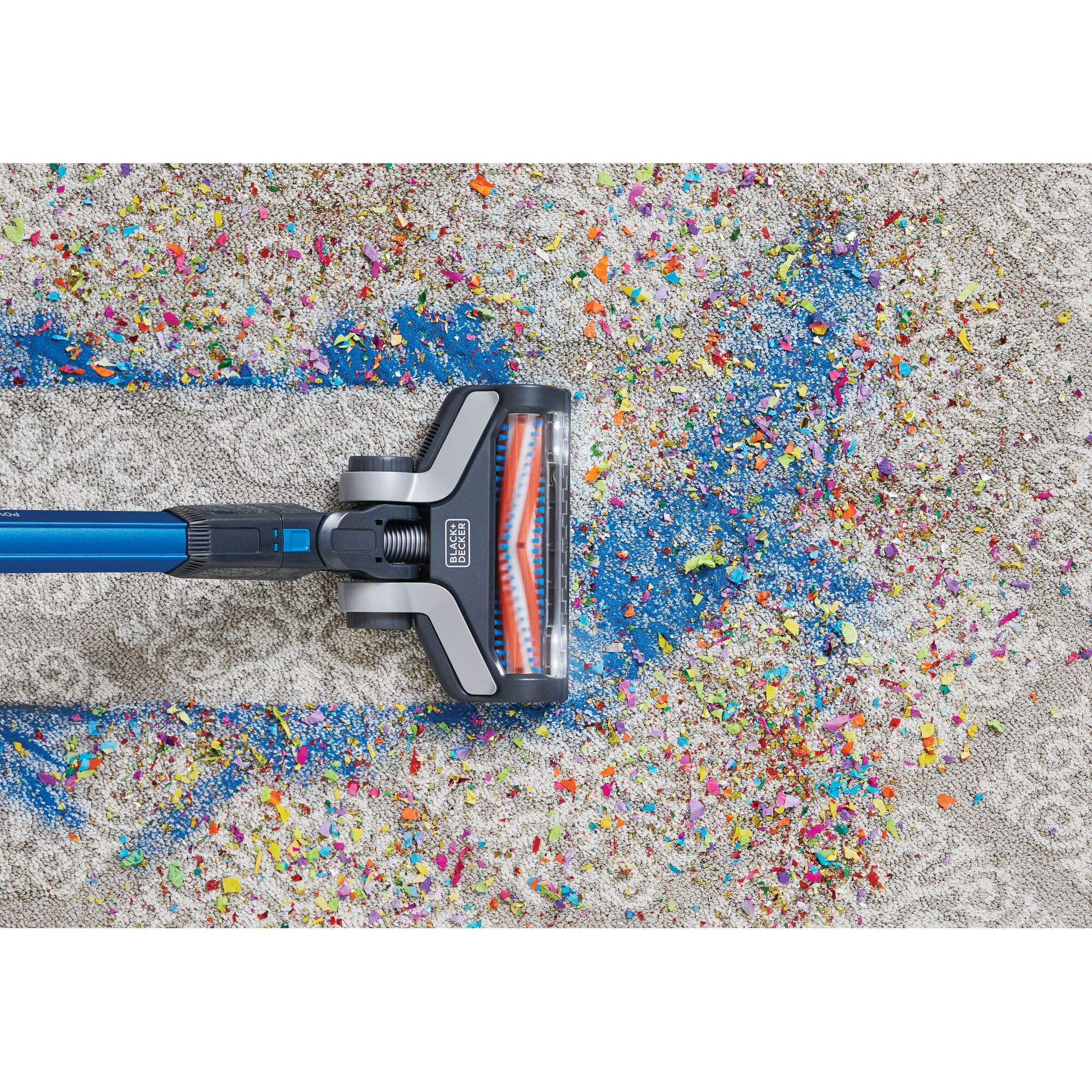 BLACKDECKER BSV2020G stick vacuum cleaning colorful debris from carpet, top view.