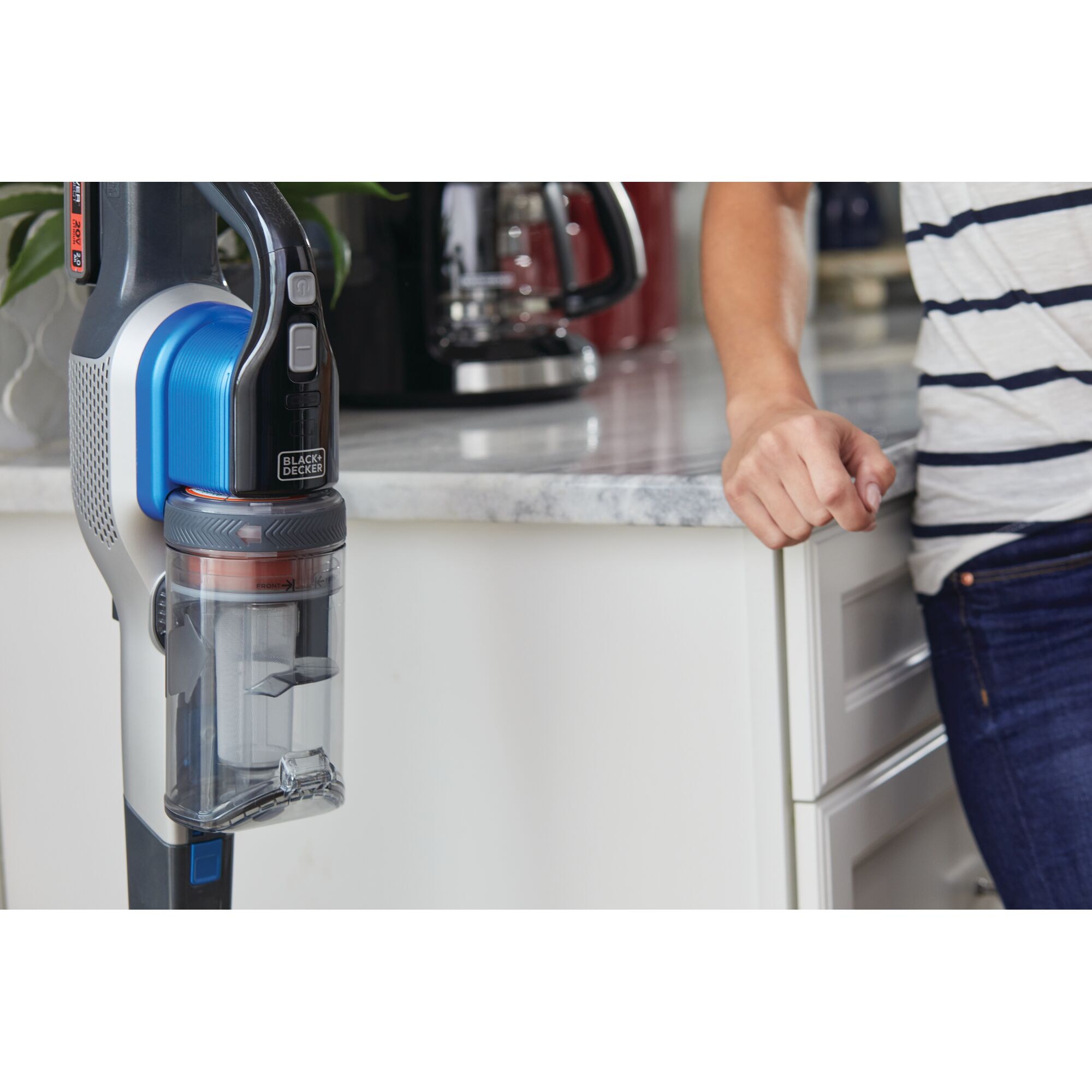 BLACK+DECKER BSV2020G cordless stick vacuum with blue accents shown near kitchen counter.
