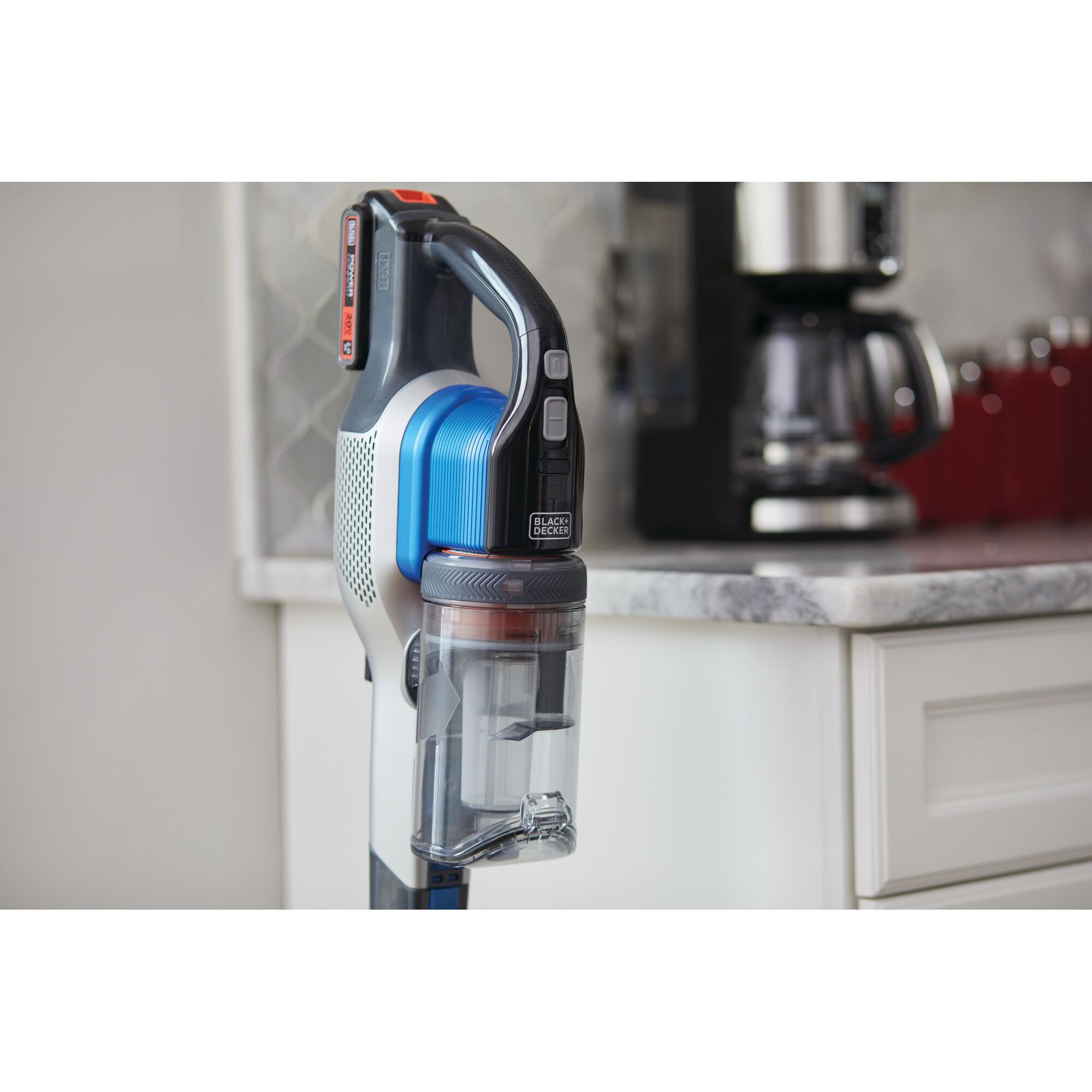 BLACK+DECKER BSV2020G cordless stick vacuum in blue and black shown standing upright in a modern kitchen.