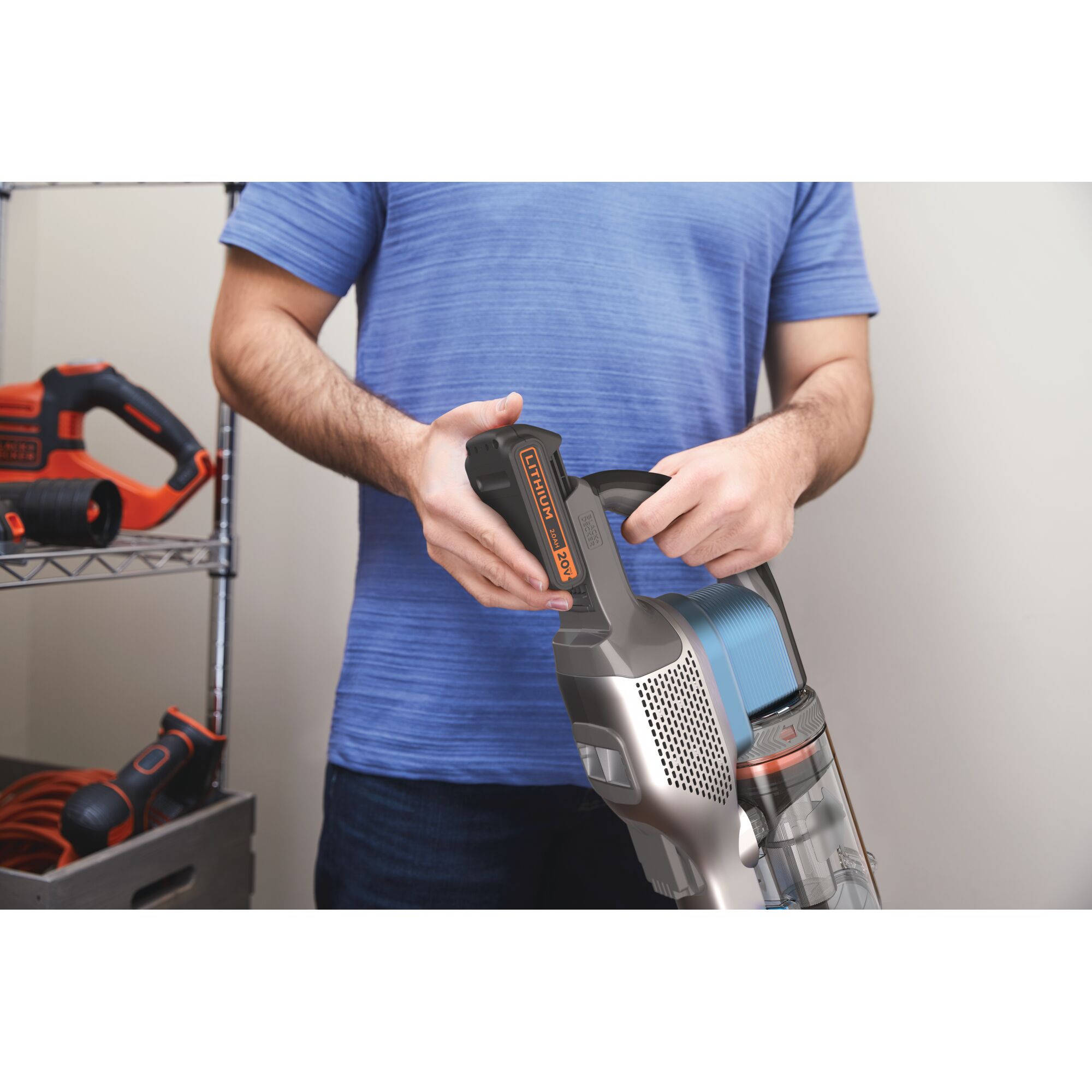 BLACKDECKER BSV2020G stick vacuum with 20V lithium battery being held by person.
