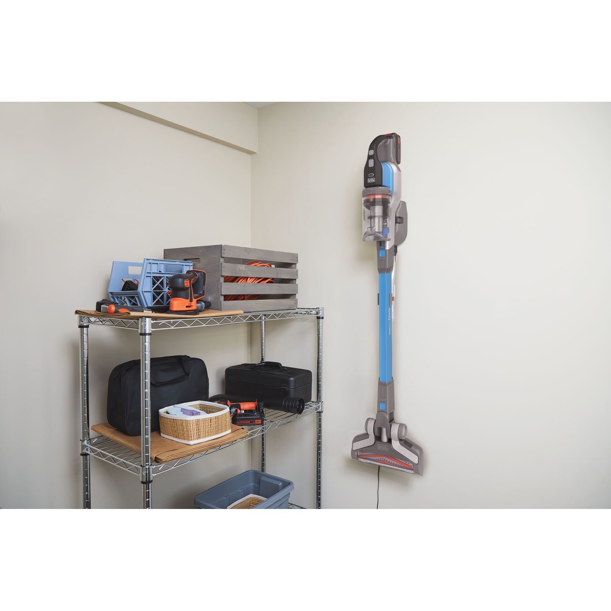 BLACKDECKER BSV2020G cordless stick vacuum mounted on wall next to shelving unit, side view.