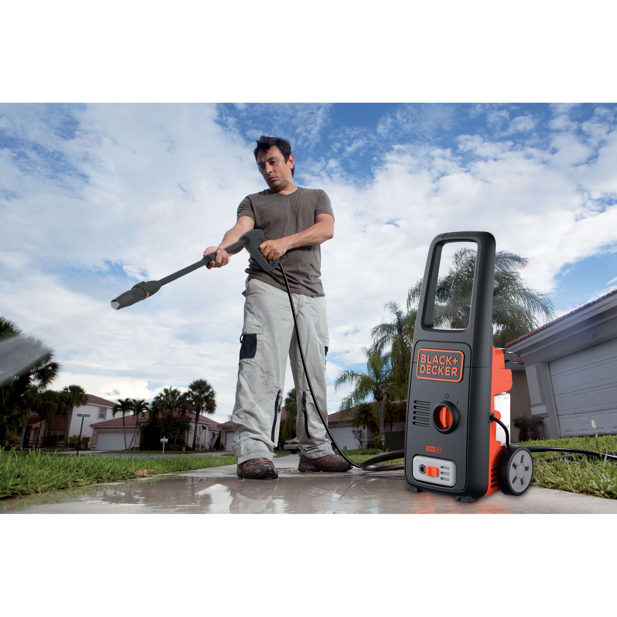 Photo of BLACKDECKER BW15 pressure washer cleaning outdoor pavement, portable design with wheels, home setting.
