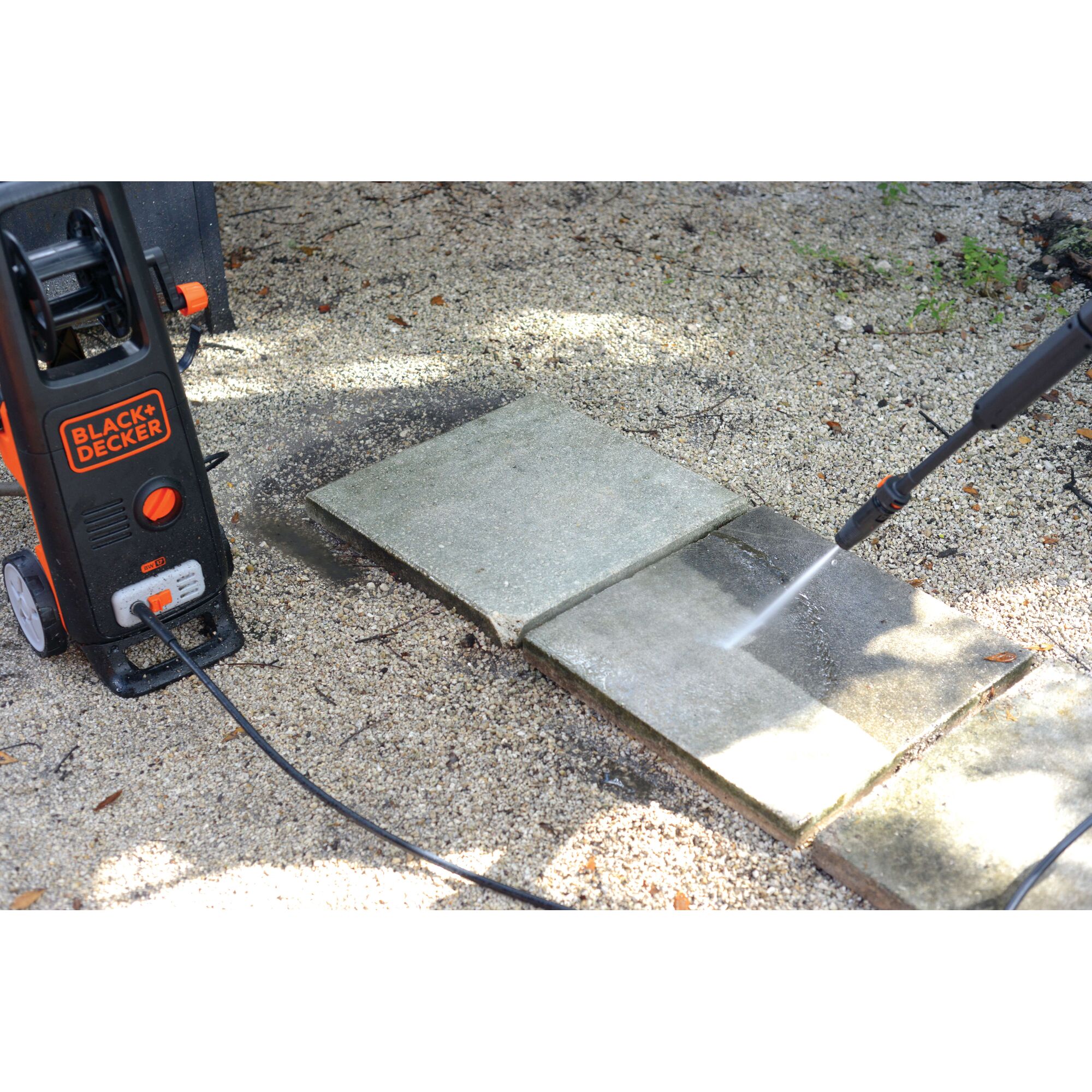 BLACKDECKER BW17 pressure washer cleaning outdoor stone tiles, left side angle.
