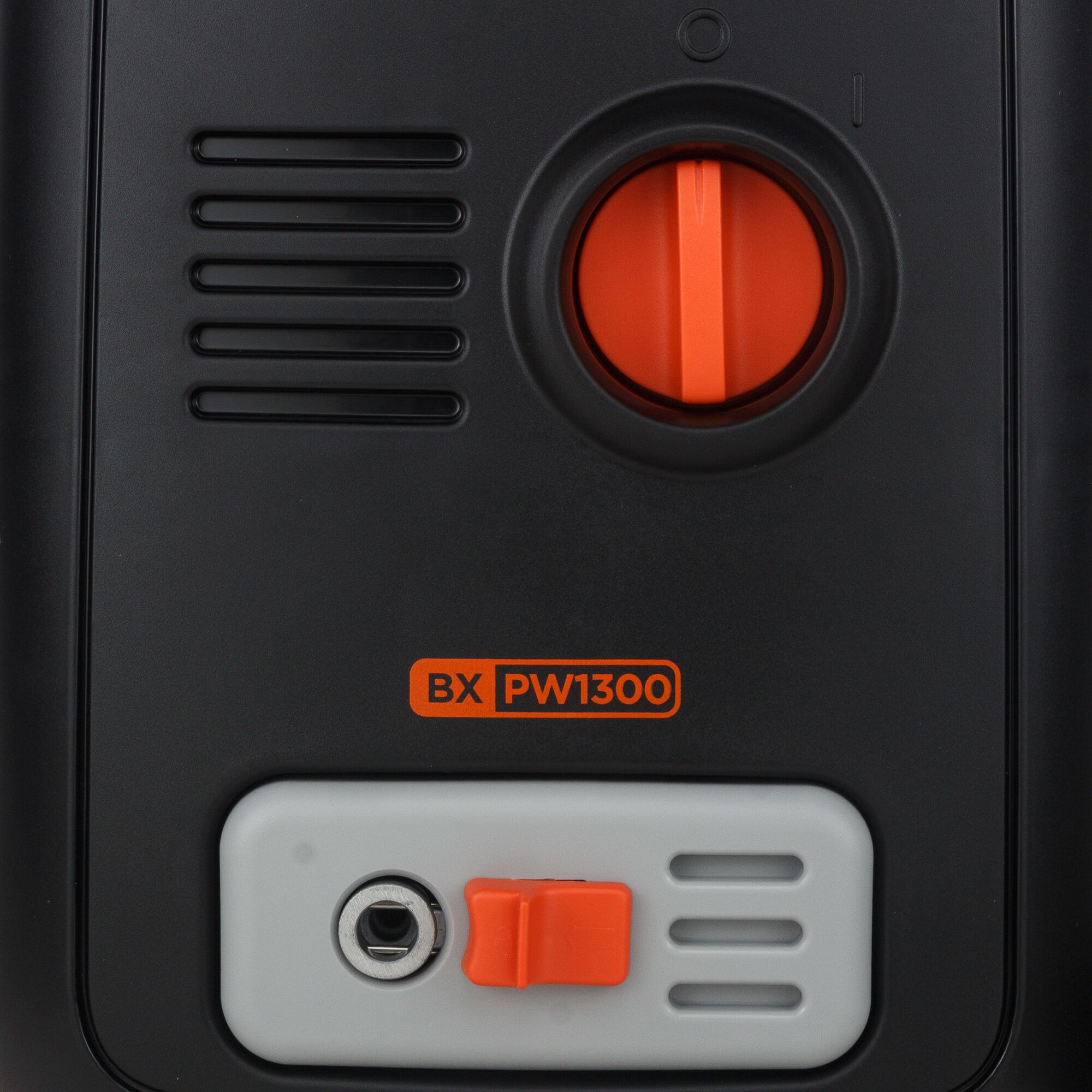 BLACKDECKER BXPW1300E pressure washer close-up showing orange dial and connector on black and gray body.