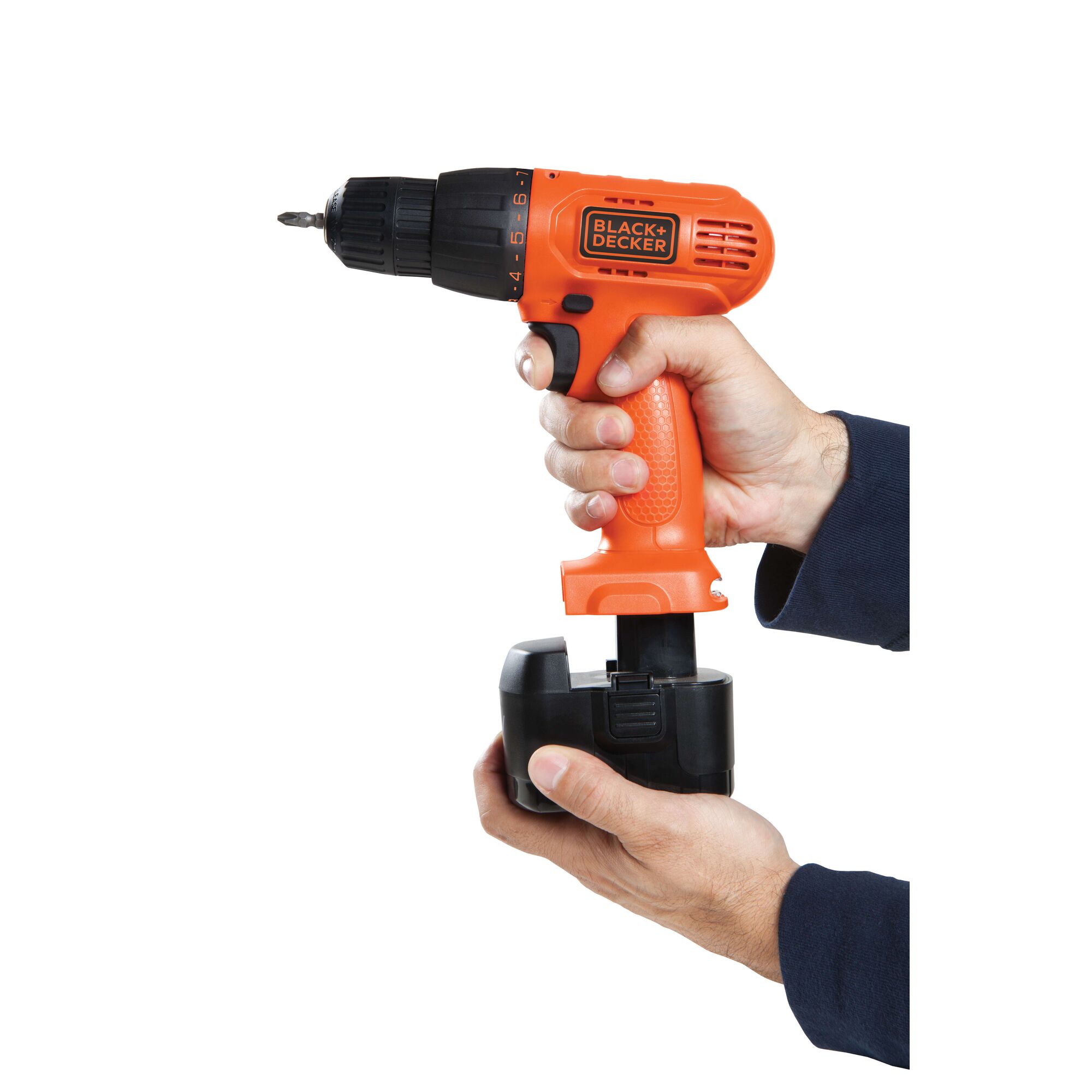 Photo of BLACKDECKER CD121K50 cordless drill in orange, handheld, battery being inserted, front angle.