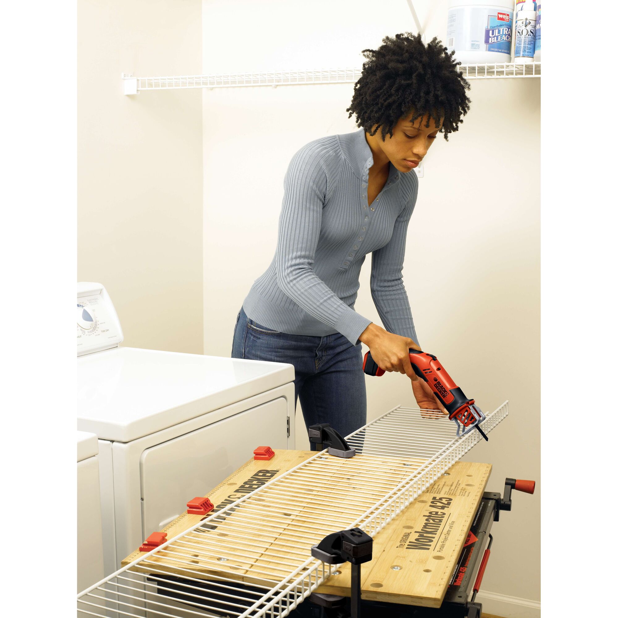 BLACKDECKER CHS6000 cordless reciprocating saw cutting metal shelving in laundry room.
