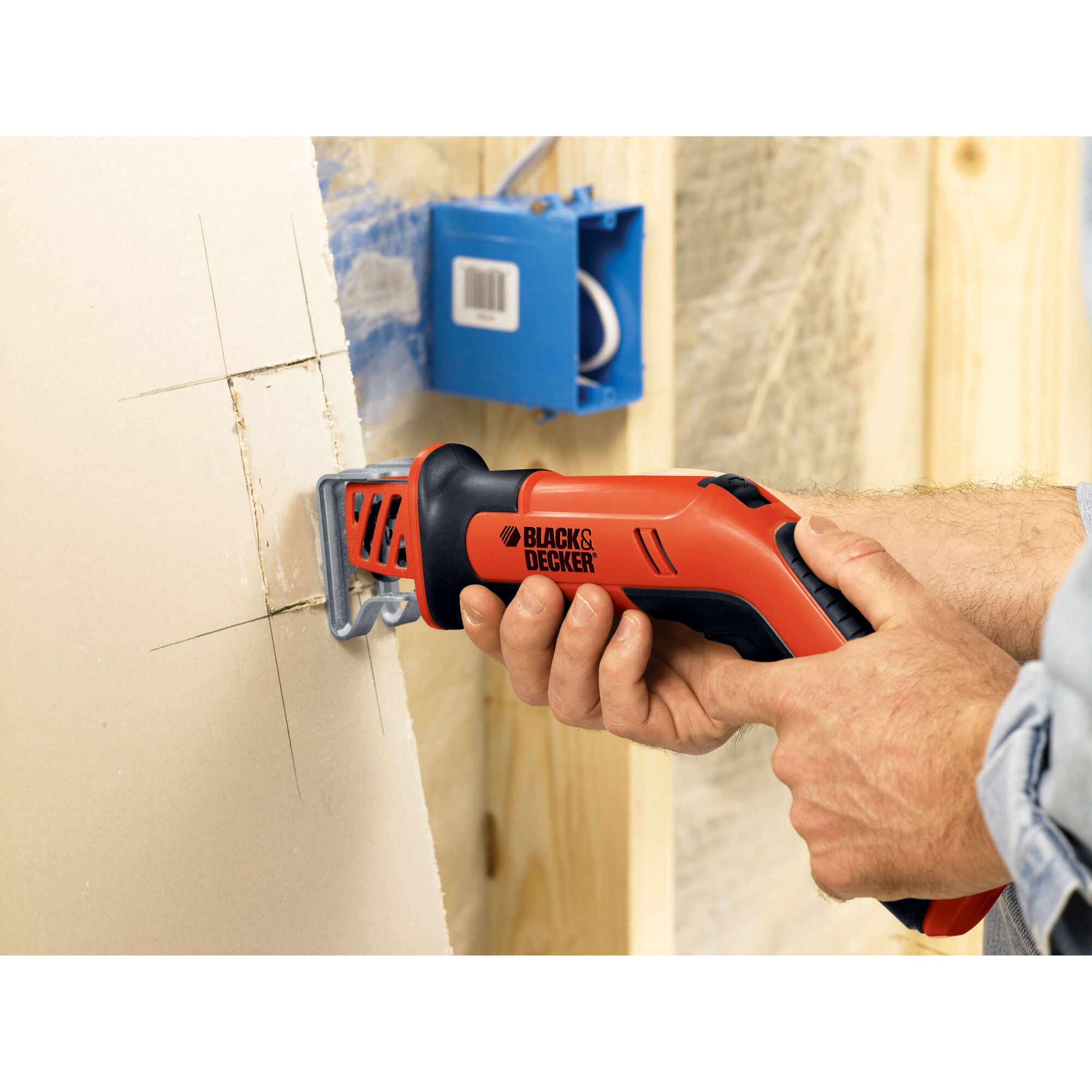 BLACKDECKER CHS6000 reciprocating saw cutting drywall near electrical box, close-up photography.